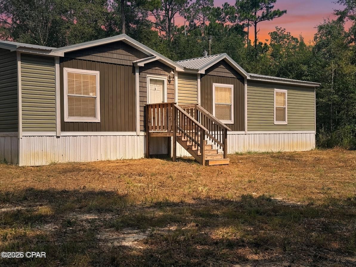 If you want privacy, this is your place!  This 2022 3 Bedroom, 2 Bath Double Wide Mobile Home is situated at the end of the road through a gated shared entrance surrounded by beautiful oaks on the spacious 1.7 acre lot.  The home features lovely farmhouse finishes with a split bedroom plan in an open living space with fireplace.  Home looks brand new.  The home is located at the end of the road with a shared gated entrance.