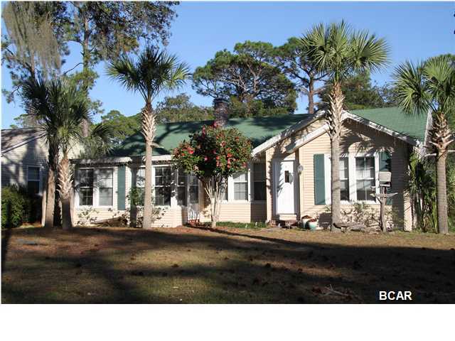 You'll love this place! This classic Florida Cottage in the ever popular COVE, a quiet neighborhood in a great location, is an easy bike ride or drive to the historic waterfront in downtown Panama City, FL. This home has been completely and tastefully updated. It is a classic split bedroom design on a large corner lot, with ample parking for four cars - two under the carport, and a fenced back yard. From the moment you enter, you will appreciate the original hardwood floors throughout the main living areas, and the 1930's craftsman architectural features. Picture yourself relaxing in the sun drenched enclosed porch that can double as a study or den. The recently remodeled and updated master bedroom contains a huge walk-in closet and french doors that lead you to a private patio where