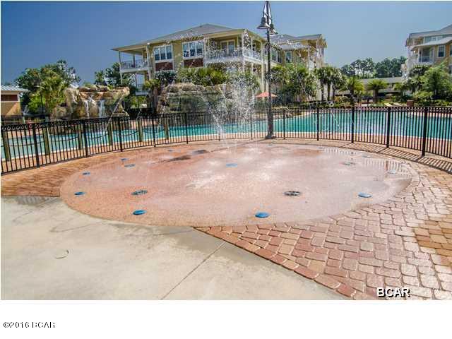 Experience an oasis at the beach. This executive 1 bedroom, 1 bath, 1071 sq. ft. condo with a study/office in the beautiful and tranquil gated community of Island Reserve, located off Front Beach Road in Panama City Beach. This open floorplan features hardwood flooring in the living area, tile in the kitchen and bathroom, and plush carpet in the bedroom and bonus study, all with 10' ceilings. The well appointed kitchen includes granite countertops and island, stainless steel appliances, and detailed cabinetry. Condo amenities include washer and dryer, window coverings, private porch and covered garage parking and entry. Water, sewer, and garbage are included. Pets are not allowed. Island Reserve amenities include game room, fitness center, indoor sports court and resort style pool. The Island Reserve community features gorgeous landscaped courtyards with paved walks and fountains. Club house boasts fitness center, media center, indoor basketball court, aerobic/fitness center, and game room/community room. And don't forget one of the largest residential swimming pools in Northwest Florida, almost 1 acre complete with lap area, water fountain, waterfall and hot tub. It is truly an island in the middle of the beach.