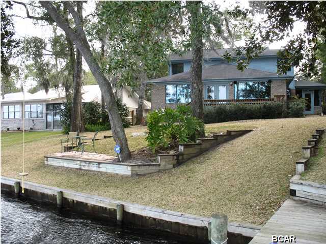 EXPANSIVE VIEWS OF DEERPOINT LAKE can be yours with this fabulous lake front home! Framed with gorgeous Heritage Oaks, the home's design showcases the lake from the living areas. The 16x33 dining/living room is walled with windows, so you don't even have to be outside to enjoy the view! Large kit has lots of cabinets and counter space plus 2 large pantries! Off the kit is a heated and cooled Fl room that works great as an office. Lge laundry room leads to the HUGE (25x27) garage that also has a workshop attached. The MBR is on the first floor, has 2 walk-in closets and the MBA has dbl vanity and large shower. Upstairs are 3 big bedrooms. One bedroom has a built-in shelves and cabinets and a cedar closet. Another has a walk-in closet and the 3rd bedroom has fabulous views of  the lake...making a great study nook! Exiting the dining/living room, there is a deck, perfect for a morning cup of coffee and a lower deck which is a great spot for grilling. There is also a fire pit closer to the water and a patio at the water's edge. Catch your dinner from your dock or just sit and enjoy the serenity of this lovely spot. Don't miss this opportunity for a lake front home. Age, rm sizes, sq footage are estimates. Please measure if concerned.