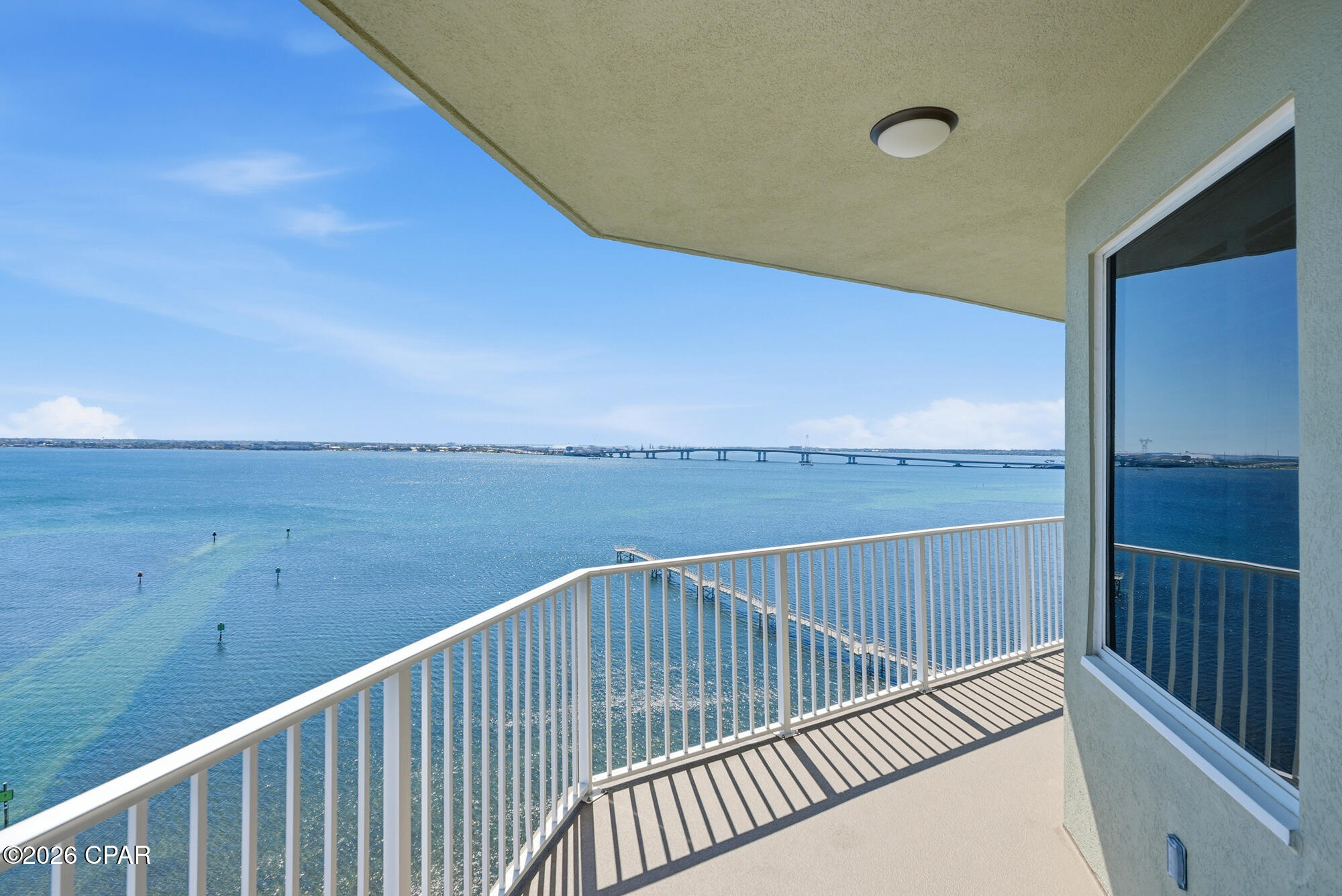 Welcome to Hibiscus by the Bay, one of the most beautiful and distinctive waterfront communities in the area, offering luxury living along the shores of St. Andrews Bay. This stunning 11th-floor end-unit 3 br 2.5 bath condo features over 2,000 square feet of thoughtfully designed living space, with breathtaking bay views from nearly every room.
Step inside to an open and airy floor plan filled with natural light and expansive windows. The spacious living area flows seamlessly onto a large bayfront balcony--perfect for enjoying morning sunrises and the sparkling evening lights of the Hathaway Bridge. Elegant finishes include tile flooring throughout, solid wood cabinetry, granite countertops, stainless steel appliances, and designer lighting.
The kitchen is both beautiful and functional, featuring custom poplar cabinetry with a rich walnut finish, a peninsula bar, dual convection ovens, a 36'' induction cooktop with stainless hood, travertine backsplash, and abundant storage. A custom wine bar with a Sub-Zero under-counter refrigerator and wine cooler adds a touch of sophistication for entertaining.
The luxurious primary suite offers private balcony access, tray ceilings, a spacious walk-in closet with updated closet storage system, and a spa-like bath with double vanities, granite counters, a custom tiled shower, and extra storage closet. Two additional bedrooms overlook the marina, offering scenic views that stretch to the West Bay Bridge. One of the bedrooms features a Murphy bed. Second bathroom features a new custom tile shower. 
This meticulously maintained residence includes numerous upgrades such as Cat 5 hurricane-rated sliding glass doors, double-pane windows, and a laundry area with granite countertops and stylish finishes. There is also a water filtrations system, whole home surge protection, and plantation shutters. 
Hibiscus by the Bay is a gated, non-short-term rental community set on 11 acres of prime bayfront property. Residents enjoy resort-style amenities including a bayfront pool and hot tub, fitness center, tennis and pickleball courts, private marina with boat slips (frequently available for purchase as well as garages), a 400-foot fishing pier, community room, library, and multiple grilling and picnic areas. The entire complex was repainted in 2024, including buildings, balconies, and breezeways. 
Whether you're a boating enthusiast, a full-time resident, or seeking a peaceful coastal retreat, this exceptional property offers the perfect blend of luxury, privacy, and waterfront living.
All measurements are approximate; buyer should verify if important.  Water heater 2025, HVAC 2021, Water system 2025, Surge shield 2025, Plantation shutters 2025.