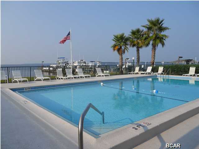 REDUCED!AND READY TO MOVE IN and ENJOY.  Freshly painted, repairs completed and tenant free for now.  Landmark on St. Andrews Bay. Views of Shell Island and the Pass, this unit is updated and well maintained with tile floors in the living and dining, a open, bright and functional kitchen and makes a great vacation, rental, or permanent residents. You'll love the location on the Bay with access to all the amenities including a dock, fishing station, and 2 great pools. FL living at its finest in this tucked away local hidden secret. This is a must see and priced to sale.