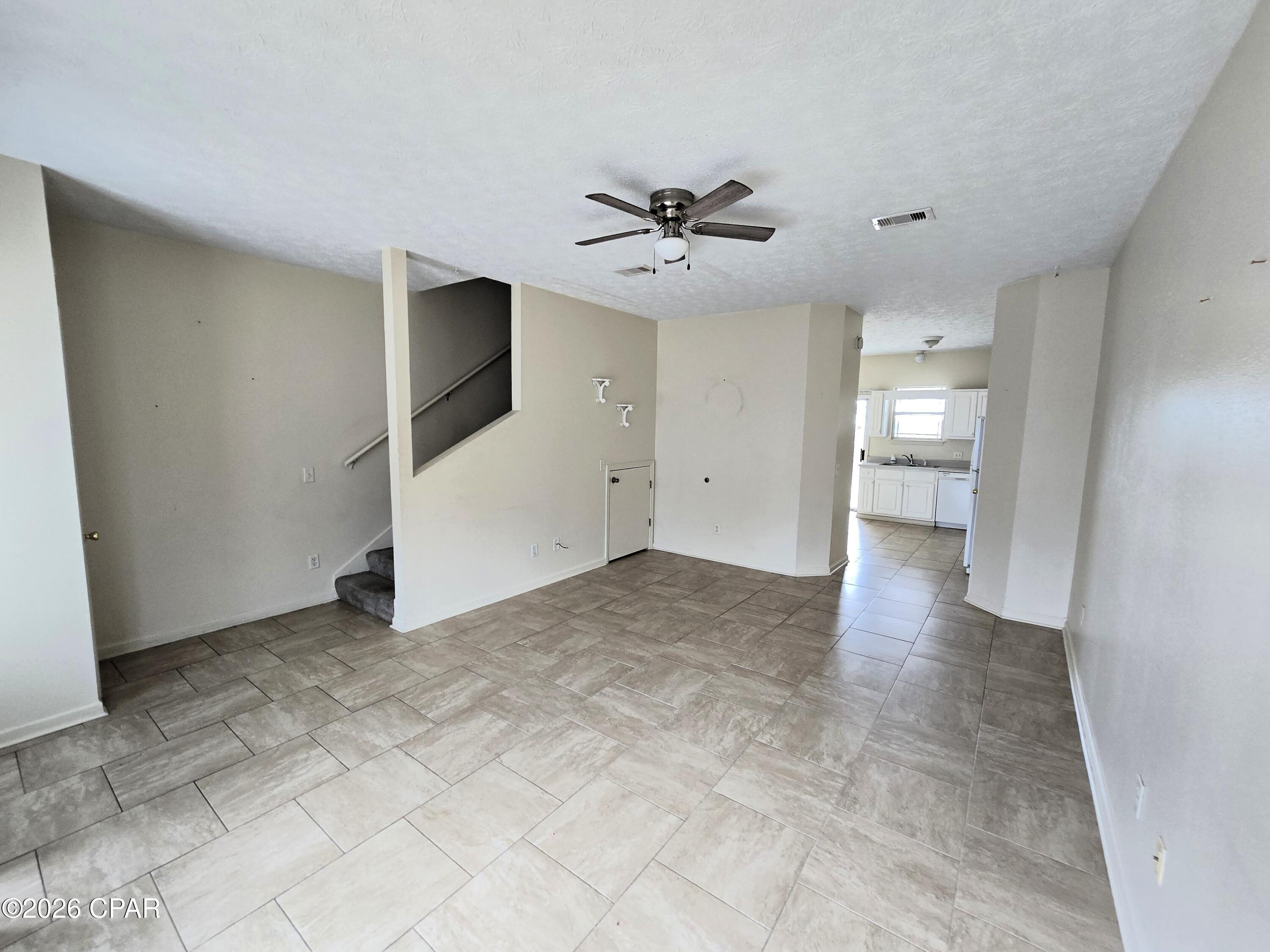 Just a quarter mile from Public Beach Access #11, this two-bedroom, two-and-a-half-bath townhouse puts sandy toes and salty air within an easy reach. Grab the golf cart because this is that kind of laid-back neighborhood, and getting to the water couldn't be simpler.

Downstairs you'll find a roomy living area that flows into the kitchen and dining space, plus a handy half bath so guests don't have to trek upstairs. On the upper level, both bedrooms have their own full bathrooms, which means no more hovering outside the door waiting your turn. The primary even opens onto a private balcony, perfect for morning coffee or unwinding after a beach day.

Outside, the privacy-fenced backyard gives you a little retreat of your own, and there's outdoor storage for all the paddleboards, coolers, and beach chairs. The paved driveway is generous enough for four vehicles, so parking is never a headache when friends roll in.

Here's the exciting part. Short-term rentals are allowed with an approved application, so this one has real income potential in a beach town that stays busy year-round. Bring your vision and a few personal touches, and you've got a smart investment or a fun getaway. No homeowners association fees to worry about, either.

You're close to Tootsies, Pier Park, and all the fun the coast offers. Opportunities like this near the beach don't linger long, so schedule your showing today and come see it for yourself.

*Information provided is deemed reliable but is not guaranteed and should be independently verified by the buyer*