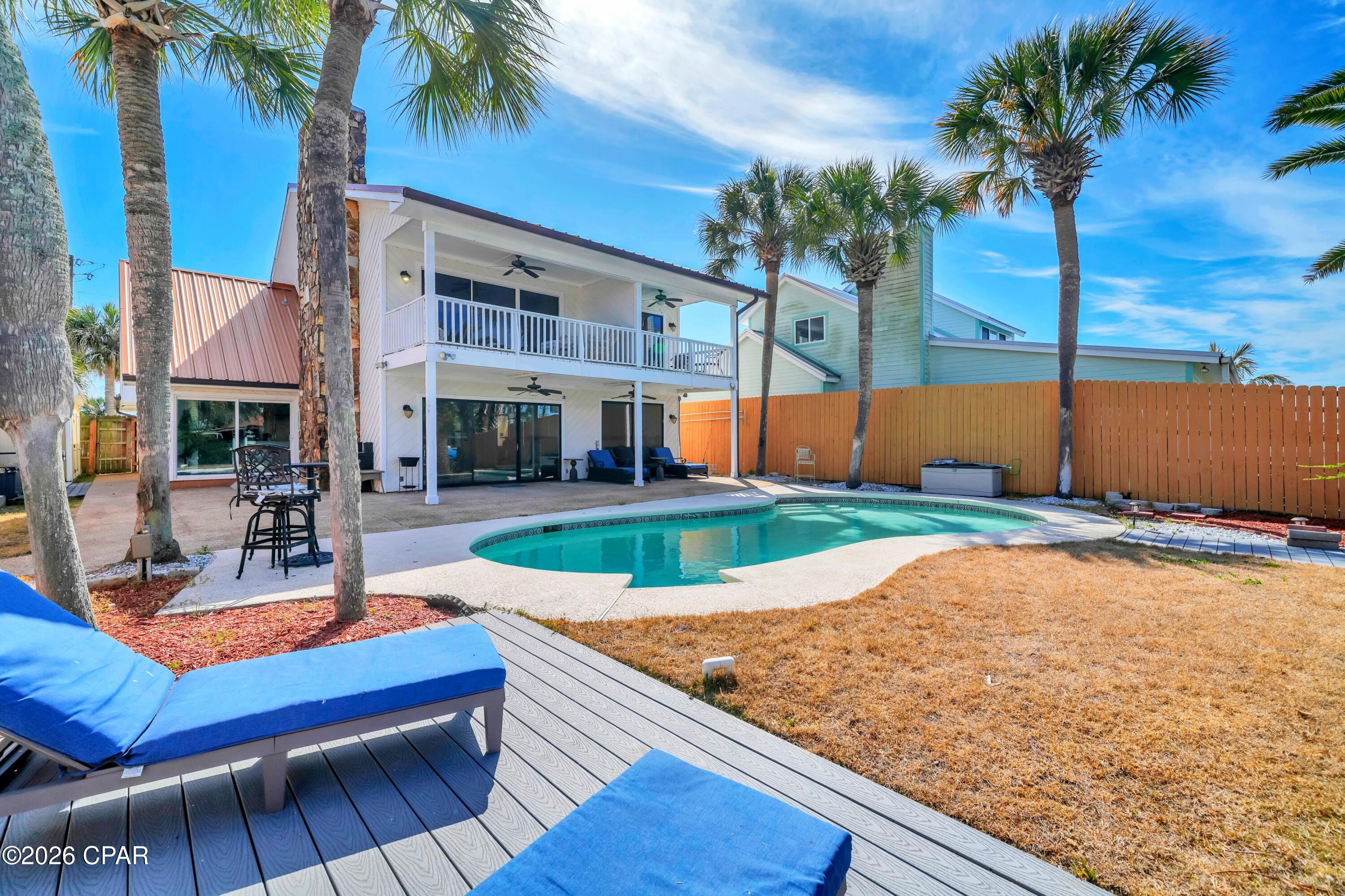 Experience the ultimate waterfront lifestyle with this fully remodeled coastal retreat on Grand Lagoon! Ideally positioned just minutes from the Gulf, this exceptional property offers a rare combination of modern luxury, double boat slip deep-water access, and outstanding short-term rental potential, all with no HOA restrictions. 

Thoughtfully renovated from top to bottom, the home features 5 bedrooms and 4 full bathrooms, including a spacious converted garage that serves as a private fifth bedroom with its own en-suite full bath. This flexible space can also function as a game or hobby room, making it ideal for maximizing rental occupancy and guest experience. The layout is well designed with two bedrooms on the first floor and the primary suite plus two additional bedrooms on the second level. 

Upon entering, the bright, contemporary design showcases fresh paint, updated lighting, and stylish fixtures throughout. New flooring flows seamlessly across the home with no carpet, creating a clean and low-maintenance environment ideal for both full-time living and high-traffic use. The fully redesigned kitchen is a standout, featuring white cabinetry, sleek countertops, and brand-new appliances that offer both style and functionality. Two of the three upstairs bedrooms feature private balconies with water views. Plus the primary bath has a jacuzzi tub and separate shower. 

Outdoors is resort-style living at its finest! The backyard is built for entertaining, complete with a gunite pool, relaxing spa, and multiple levels of newer Trex composite decking all with lagoon views. For the boating and water enthusiasts, this property is exceptionally well equipped with deep-water frontage and an incredible covered dock! One side features a 40' x 20' roof over a 24,000 lb boat lift that can accommodate approximately a 35' boat. The second dock includes a 16' x 24' roof over a 12,000 lb lift suited for up to 21'. Two jet ski float pads provide additional convenience and storage. This convenient location provides easy access to St. Andrews Bay, Shell Island, and the Gulf. Additionally, the home has already been connected to city sewer, which is both expensive and rare in the lagoon area. 

Situated on a quiet stretch of South Lagoon Drive and only a few blocks from the area's renowned beaches, Rick Seltzer Park, and multiple dining options, this property is ideally positioned to capitalize on Panama City Beach's strong vacation rental demand. Whether utilized as a primary residence, second home, or income-producing investment, this turnkey waterfront property delivers exceptional versatility and value. Schedule your showing today. A walk-through video is available