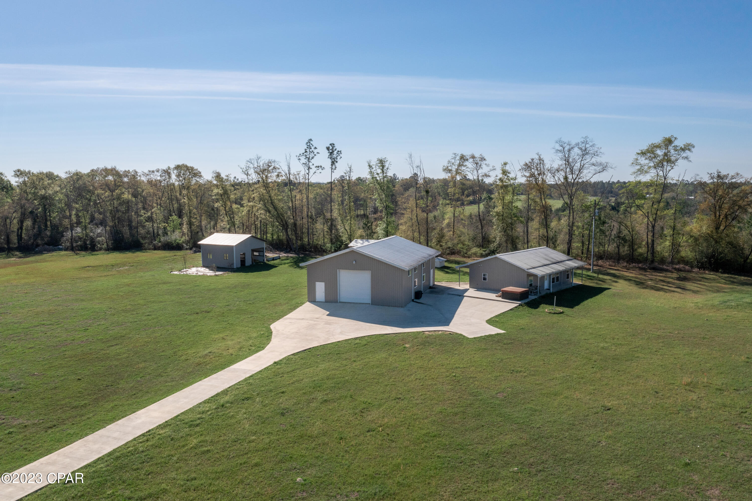 You don't want to miss this custom all steel construction home with a matching 36x50 detached garage / workspace with additional living quarters. The property is fenced in with a stable perfect for horses. The main house sits high and dry with the most beautiful view. The workshop is rated for 220 mph winds. The detached workshop has 1,000 sq ft of living space as well as the main house. The new 360ft driveway is perfect for all the gatherings you will have!