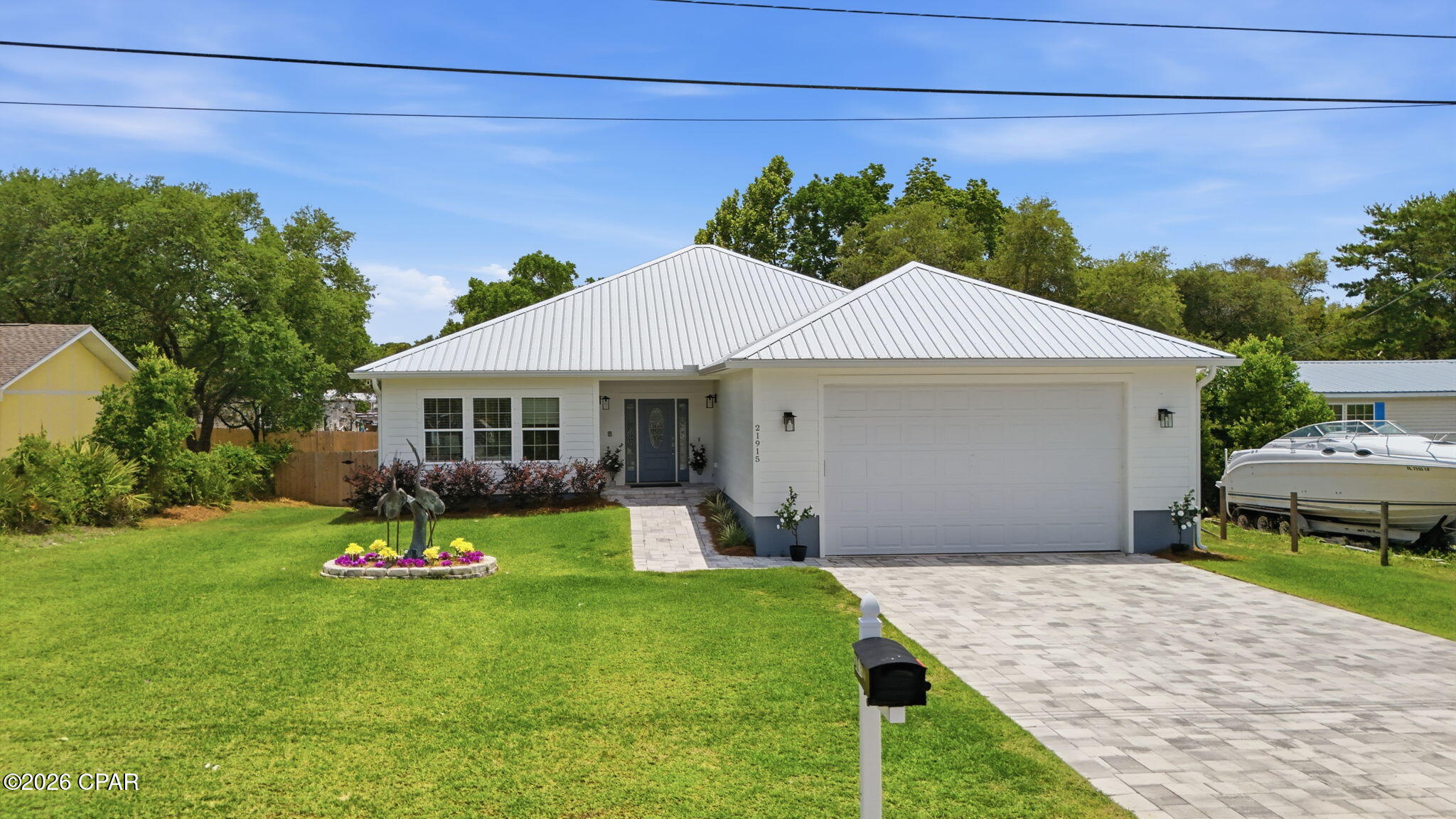 Welcome to your home of a lifetime located in a quiet community less than 15 minutes to the Gulf of America.   This spacious home was engineered with comfort, security, and significant insurance savings through superior build specifications.   Enjoy the open concept with 9 ft ceilings and 8 ft solid doors.   Walls are extra-insulated for quiet from room to room.  Three bedrooms and three full baths are available.  The dual master suites  are ideal for multi-generational living with solid wood doors,  key locks, spa-like bathrooms, walk-in closets, and private access doors to the screened back porch and out to the elevated deck.    Luxury vinyl floors run throughout this home.  Mop sinks in both the garage and laundry provide easy maintenance.  This Smart house allows insurance savings for years to come with High-tech Cat 5  construction, metal roof,  hurricane fabric protection, and  Low E glass windows.   The  circulating ''Instant'' hot water system ensures comfort while significantly reducing water waste on monthly bills.   Enjoy breakfasts and sunsets on your screened porch and large elevated deck overlooking the 80x150 ft lot.   The over-sized garage measures 840 sq ft (28x30ft)  - with 12 ft ceilings and 10 ft door. Bring your RV, boat, or multiple vehicles.   The pave-stone driveway is  extra wide and extra long to accommodate 4 vehicles.