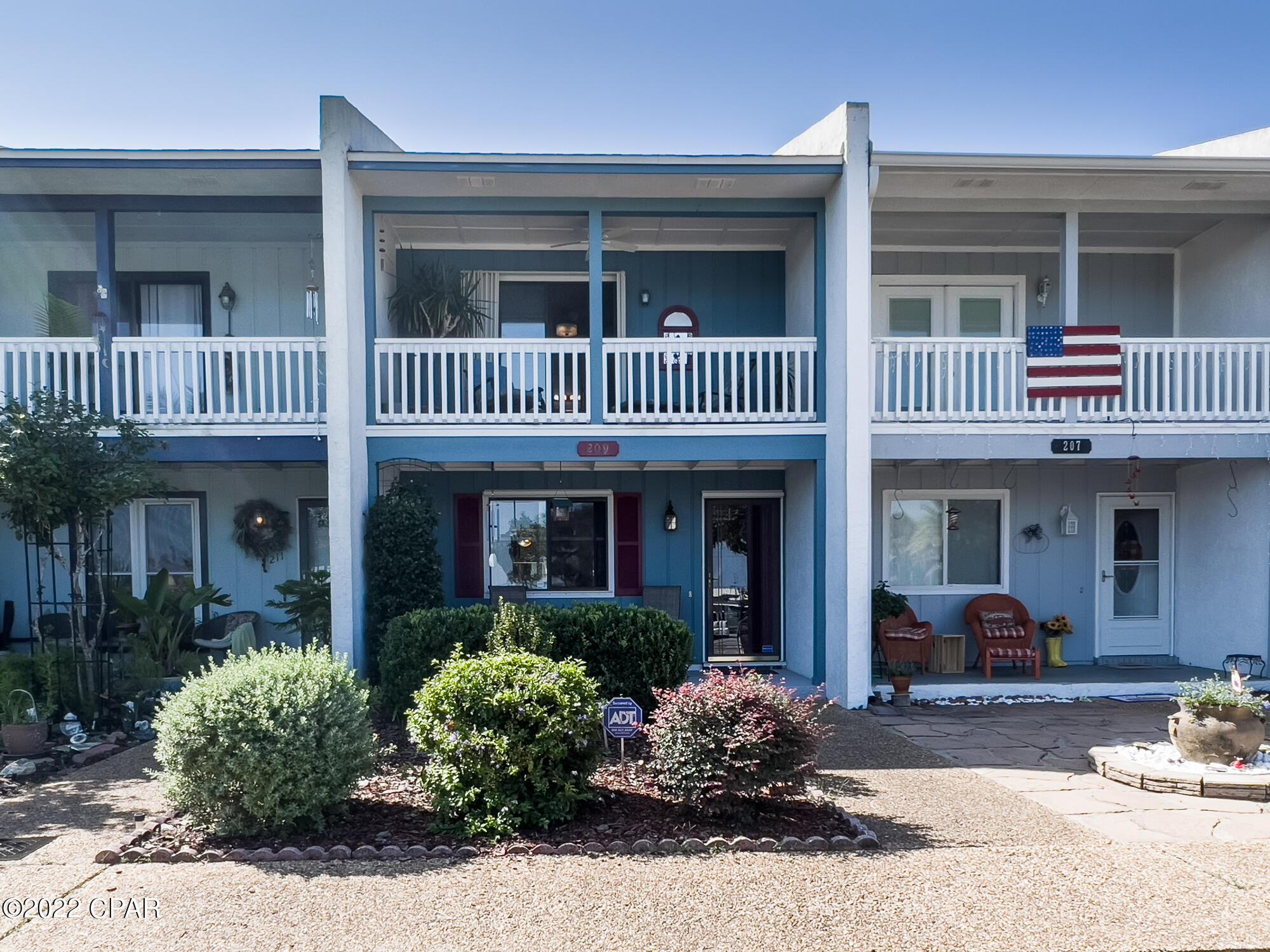 CURRENTLY UNDER CONTRACT, SELLER WILL CONSIDER BACKUP OFFERS.  Check out this super cute, immaculate & well maintained townhouse in Lynn Haven with views of the bay.  Original owner, 2 bedrooms, 2.5 baths, located across from Leslie Porter Park!  Enjoy views of the bay and watch happenings at the park from your front porch or primary bedroom balcony!  Both bedrooms have en suite baths.  There is also a sun porch and fenced backyard to enjoy your privacy.  New roof, HVAC, water heater, and plumbing fixtures in 2019.  Includes hurricane shutters and all appliances, including washer & dryer.  Located just 17 miles from ECP airport, close to WalMart, shopping and dining, and just 1/2 hour from beautiful Panama City Beach.