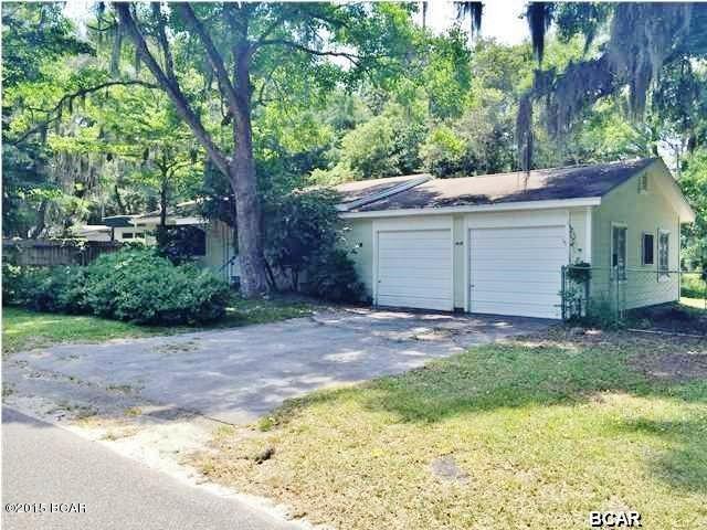 What an adorable home on a shady, quiet street in Southport! Situated on 3 lots, this cute home features original hardwood flooring in the living room and bedrooms. The spacious kitchen has updates that include beautiful cabinets, new countertops, and a new stove. There is even room for a dining table! Open the back door and step into your own private oasis. The back yard has plenty of room for a garden and picnic table. There is also an oversized 2 car garage that has room for storage. The washer/dryer hookups are also located out there. Hurry and schedule your showing because this Southport charmer won't be available for long!