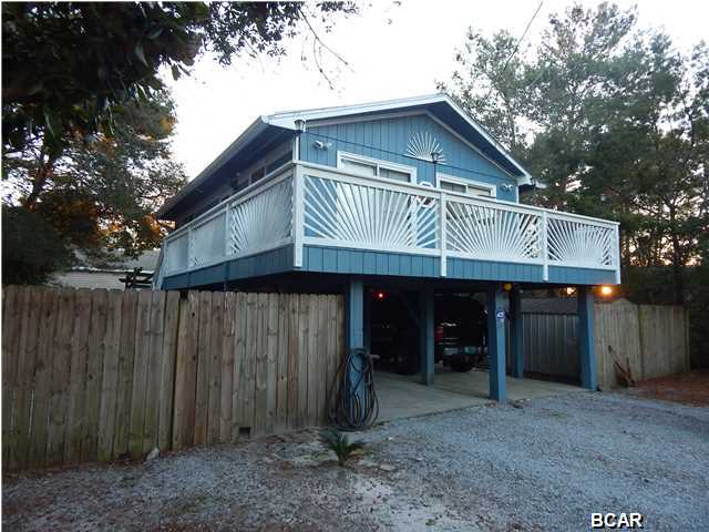 Don't get left behind as prices are going up and inventory is dropping. This home is within an affordable budget and priced to sell. Immaculate and move-in ready home close to beach and shopping. This home sits on the west end of the beach and behind Publix. Only 5 minutes from the beach. Granite counter tops in the kitchen with ceramic tile flooring. Hardwood flooring throughout. Security system comes with the home. Air conditioner unit is brand new and with workshop downstairs. Home comes with a hot tub. Home has a wrap-around balcony. A great investment, first time home buyer or vacation home.