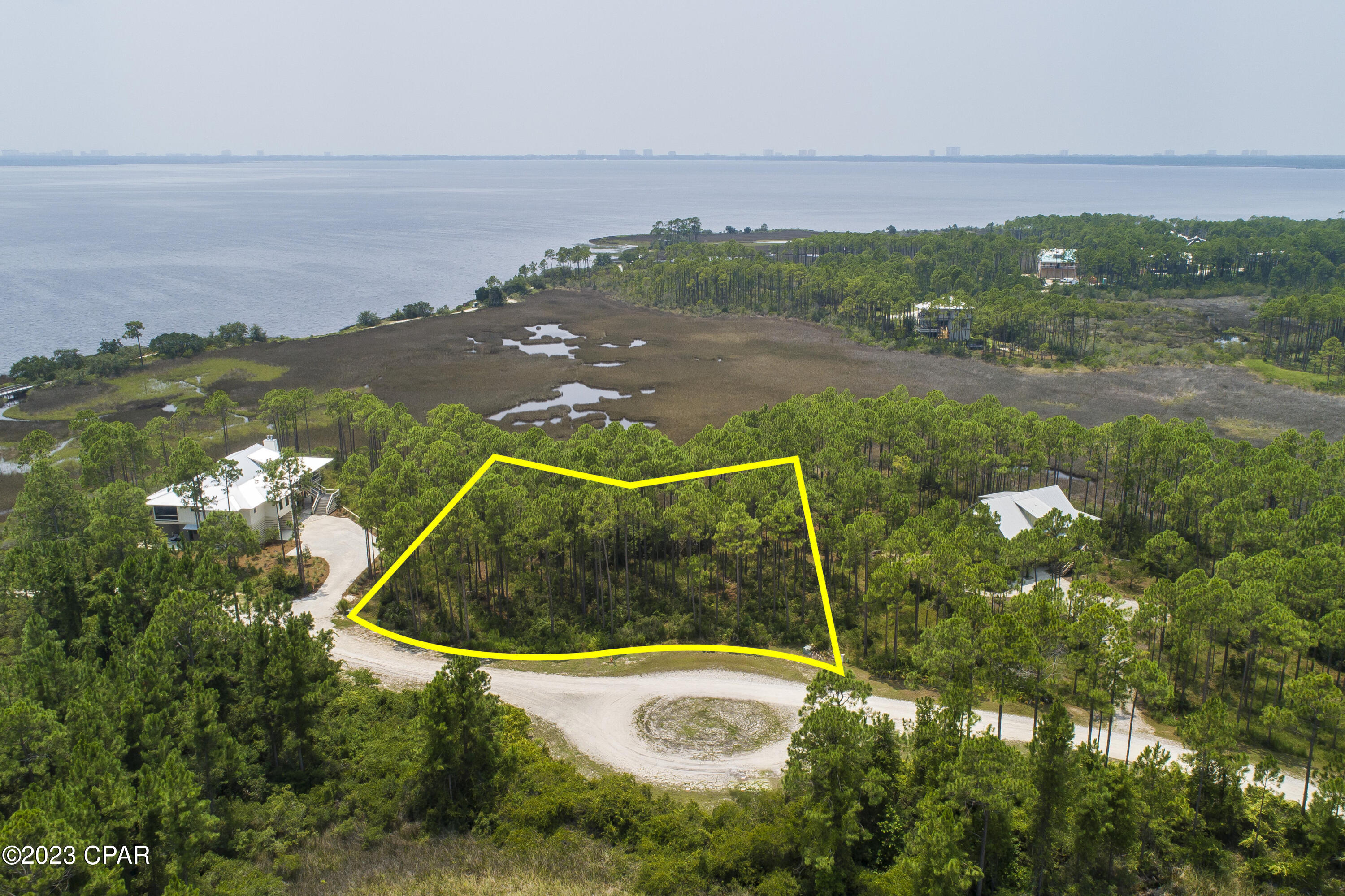 Rivercamps on Crooked Creek is a gated community set on a 1500 acre preserve with less than 450 homesites. The community is surrounded by the Intracoastal Waterway, Crooked Creek, and West Bay. Over 1000 has been dedicated to conservation and hiking trails to protect the wildlife and your future investment. This waterfront lot offers views of the Bay and beyond, all the way to the skyline of Panama City Beach.  Amenities include a boat ramp and dry-boat storage for owners. Day-use boat slips. Unlimited use of kayaks, canoes and paddleboards. According to the owner, the community has selected an architect and engaged a contractor to fast track the construction of more amenities that will make this a first-class community to be enjoyed by generations.