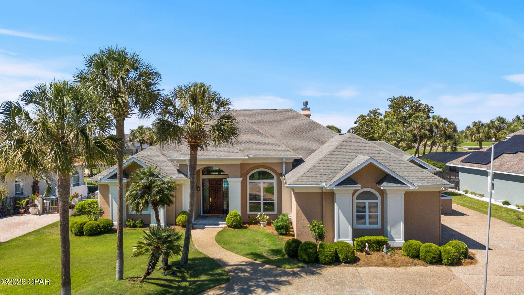 Nestled within the prestigious Queensberry neighborhood of Bay Point, this pristine 3,055-square-foot estate offers a masterclass in upscale coastal living. From the moment you pull into the expansive circular driveway, the home's grandeur is evident, highlighted by soaring 14-foot ceilings and high-end crown molding that flow through multiple light-filled living spaces. Recent premium upgrades ensure modern comfort and peace of mind, including a newly renovated primary bathroom (2025), fresh interior paint, and a suite of high-end appliances replaced between 2022 and 2024. Practical luxury is woven into every detail, from the built-in bookcases and gas fireplace to the expansive laundry suite that effortlessly transitions into a home gym or craft room.

The heart of the home is a chef's dream, featuring a farmhouse sink, gas stove, and custom cabinetry equipped with pull-out organizers. Designed for both functionality and charm, the residence boasts smart conveniences like power window shades, a central vacuum system, and floor-integrated outlets for seamless furniture placement. Seasonal decorating is made effortless by a specialized front-porch timer for holiday lighting, while the exterior is fully fortified with hurricane fabric and shutters. With a three-car garage providing ample storage and one of the two HVAC units replaced in 2022, every mechanical and aesthetic detail has been meticulously maintained.

The outdoor experience is truly your own slice of paradise, situated perfectly between the 10th hole and 11th tee box of the Legends golf course. The backyard sanctuary features a heated in-ground pool with a tranquil waterfall--newly resurfaced in 2024--surrounded by professional landscaping and breathtaking views. Whether you're watching a family of deer graze on the green at dawn or enjoying the glow of the 2023 exterior lighting at dusk, the atmosphere is one of total serenity. Tucked away from the city's hustle yet just minutes from the white sandy beaches and local amenities, this home offers the rare balance of an established, quiet community with world-class leisure right at your doorstep.