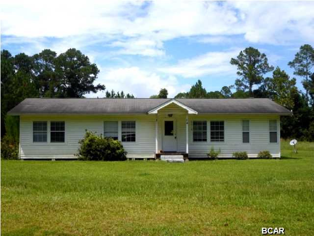 ATTRACTIVE home situated on a large lot and within a short drive to Tyndall AFB! This home features beautiful hardwood floors in the living and dining areas; a Sun room with ceramic tile flooring, a kitchen with tiled counter tops, a tiled bathroom, and a laundry room with convenient access to the backyard. The home is being sold in its AS IS condition.