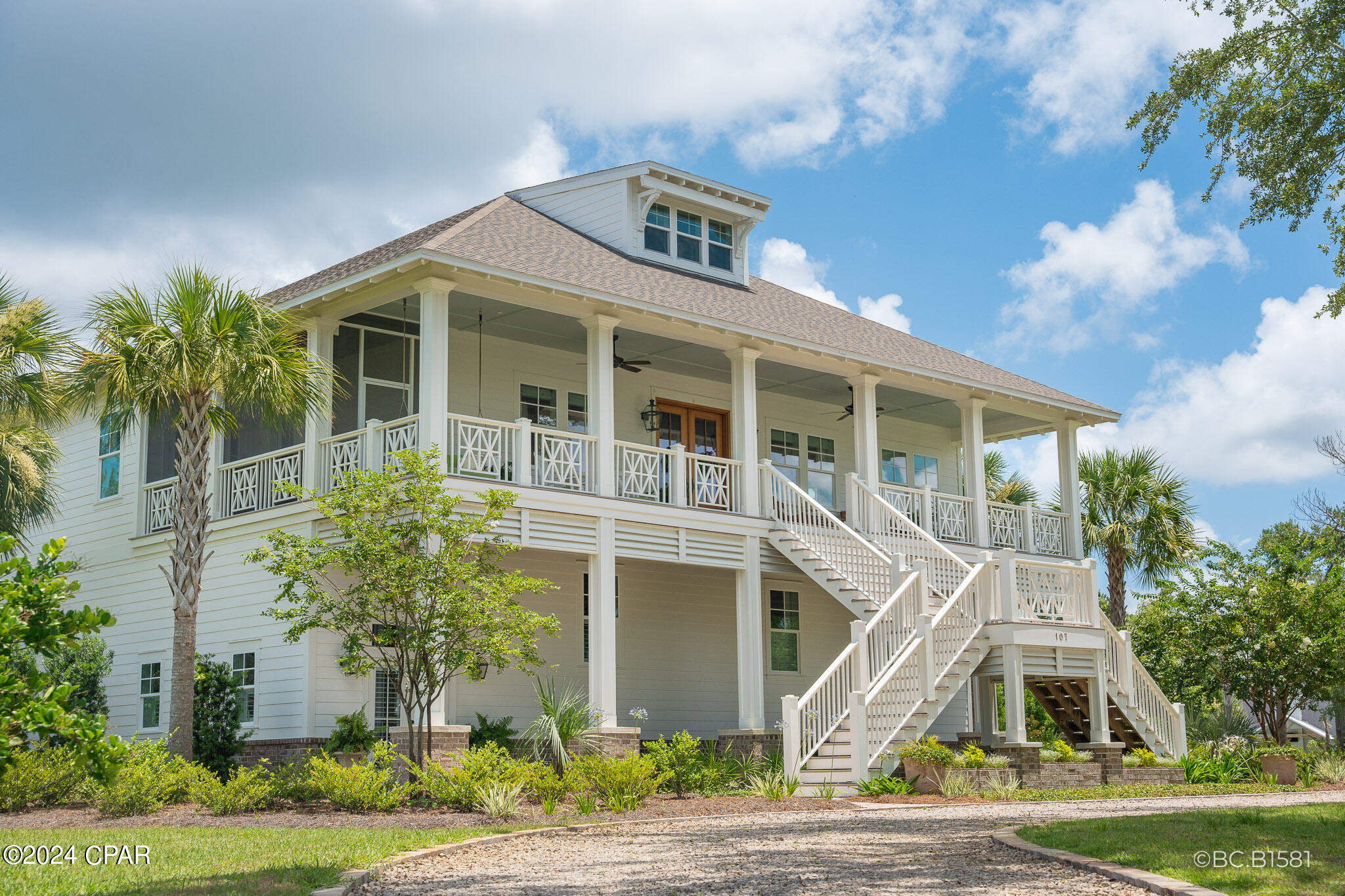 A rare 2020 Windolf-built estate on a .91-acre double lot inside the city of Port St. Joe, with panoramic views of St. Joseph Bay from every principal room. The kind of home that does not become available -- engineered for permanence and built to be passed down. Constructed to last generations: reinforced concrete foundation, full block-and-Hardie exterior, foam insulation between every interior room, hurricane-rated impact windows, standing-seam metal roof, whole-house generator, tankless water heater, natural gas, irrigation well, and underground utilities. Inside, craftsmanship reads immediately. Ten-foot ceilings, mahogany double-door entry, wide-plank Carolina Pine COREtec and hardwood floors, plantation shutters, and custom millwork throughout. The chef's kitchen features fully custom cabinetry, professional gas range with vent hood, wine refrigerator, oversized island, and walk-in pantry. A gas fireplace and built-in bookcases anchor the living room beneath French doors framing the bay. Formal dining and wet bar extend the entertaining footprint. The primary suite is a private retreat with sitting area, two walk-in closets, spa bath with garden tub, separate tile shower, double vanities, and screened porch access. A full elevator serves all three levels, and the home was designed for full wheelchair accessibility, including ADA-compliant baths, without compromising elegance. Three additional bedrooms, a bunk room, game lounge, and workshop provide flexible room for guests and hobbies. Wraparound covered and screened porches run the full length of the home. Mature live oaks, magnolias, palms, and fruit trees frame a circular drive to a three-car attached garage. RV sewer hookup, outdoor shower, and a prepared outdoor kitchen site are in place. Nearly an acre of level, walkable land -- a near impossibility inside city limits -- minutes from downtown, the marina, and Cape San Blas. Most furnishings negotiable. 3D Matterport tour available. Showings by appointment.