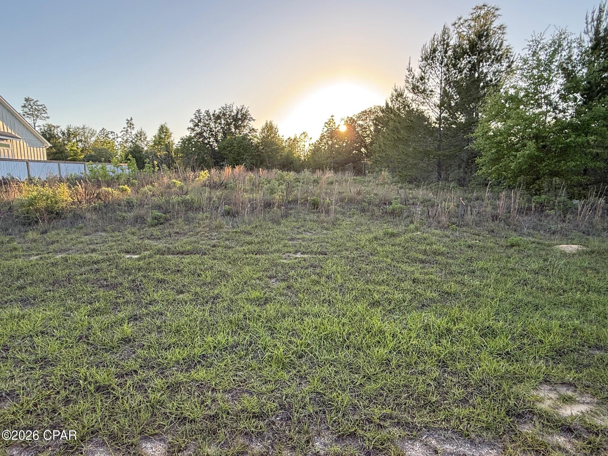 Great flat lot located in Sunny Hills! This 0.23-acre property offers a fantastic opportunity to build your dream home or invest in land in a growing area. The lot has a survey and has already been cleared, just has some overgrowth. Sunny Hills features multiple lakes and ponds ideal for fishing, as well as an 18-hole golf course. Located just 40 minutes from Panama City Beach and approximately 20 minutes from the airport. Don't miss out on this affordable piece of land in a peaceful and developing community!