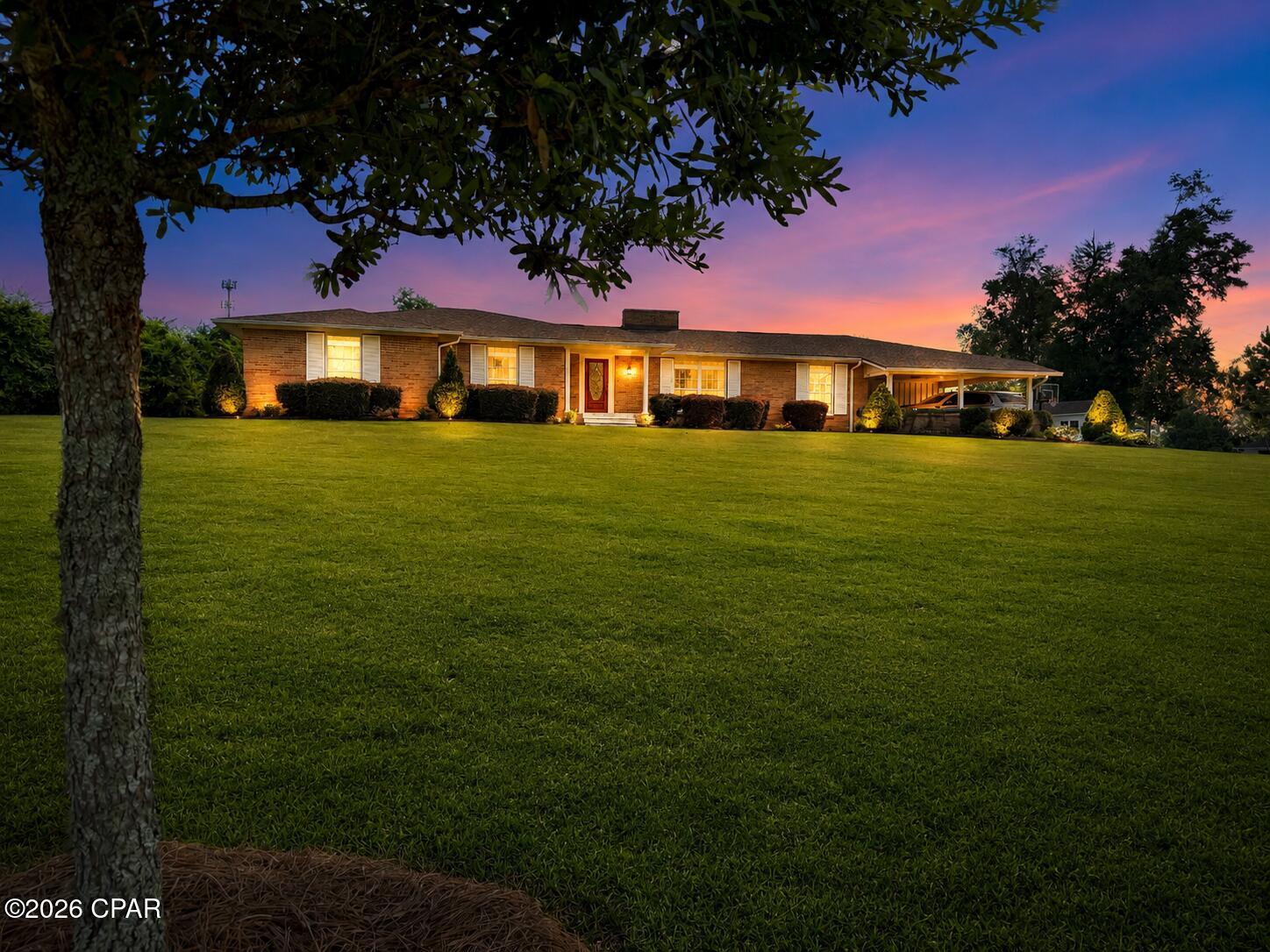 Completely rebuilt from the ground up, this stunning 4-bedroom, 2.5-bath home offers the perfect blend of modern design, functional living, and an unbeatable location in the heart of Marianna, Florida. Situated on a beautifully landscaped 1.8-acre lot, this property provides the space you've been searching for while keeping you close to everything downtown has to offer.

Step inside to discover an open-concept floor plan featuring gorgeous wood flooring, abundant natural light, and designer finishes throughout. The heart of the home is the custom chef's kitchen, thoughtfully designed with beautiful cabinetry, quality finishes, and plenty of space for gathering with family and friends.

The spacious family room is highlighted by a unique white-painted brick fireplace, soaring vaulted ceilings, and sliding glass doors that open to the fully fenced backyard, creating the perfect indoor-outdoor living experience. Outside, you'll find a charming brick patio overlooking the expansive yard with plenty of room for children, pets, gardening, or entertaining.

Need extra space? This home also features a dedicated home office or fitness room, providing flexibility for today's lifestyle. You'll also appreciate the beautifully designed mudroom and laundry area, complete with a convenient half bath, abundant cabinetry, and exceptional storage.

Location is everything, and this home truly has it all. Enjoy the convenience of being just a short walk to Chipola College baseball games, the public swimming pool, and the Chipola Regional Arts Center, where you can experience local theater productions and community events.

With modern finishes, spacious living areas, exceptional storage, beautiful landscaping, and a prime in-town location on nearly two acres, this one-of-a-kind property offers the perfect place to call home. Don't miss your opportunity to own this beautifully reimagined Marianna gem!