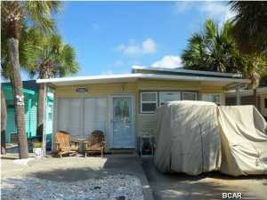 Come see this beautiful property in Venture Out Resort; the ONLY gated community in the area offering PRIVATE access to the World's Most Beautiful Beaches AND Grand Lagoon, your waterway to Shell Island and the Gulf! This unit has two bedrooms, two bathrooms, and comes completely FURNISHED! Whether you're going to MOVE IN or RENT OUT, the Sellers have made all the major updates for you: NEW AC/Heat unit, raised ceilings, indoor laundry, extra STORAGE, and more! This extraordinary home has all of the essentials, including your very own golf cart, to explore Venture Out's acreage. This family-friendly golf cart community awaits you, complete with TWO saltwater swimming pools, a boat launch and slip, a pavilion and community room, a fishing pier, playground with swings, tennis,