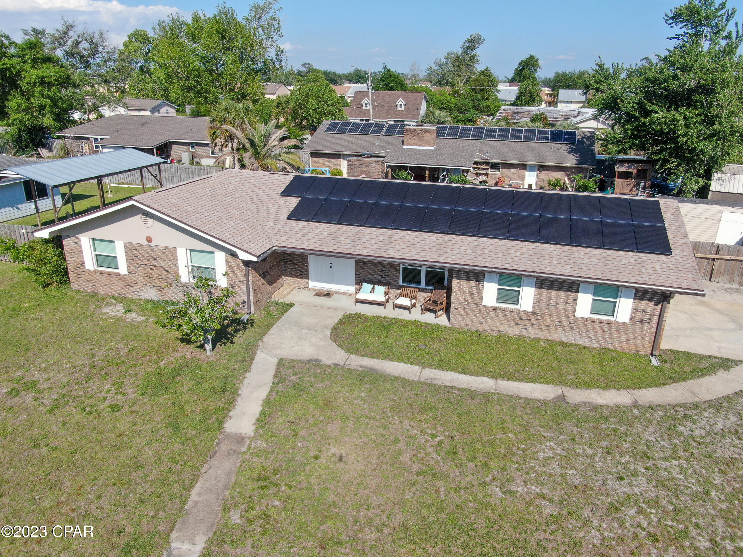 'CURRENTLY UNDER CONTRACT, SELLER WILL CONSIDER BACKUP OFFERSBRICK 3 Bedroom/2 bath home on a LARGE corner lot conveniently located just off 390 near schools, shopping, restaurants and more! Featuring luxury vinyl plank flooring throughout all common areas and bedrooms; Large living room with a wood-burning fireplace; formal dining room and spacious kitchen featuring quartz countertops, pantry and tile flooring leading to the laundry room. Laundry room features  a built-in collar activated motor driven pet door and 2 car garage. Master bedroom features a walk-in closet, and tub/shower combo. Exterior showcases a 28x11 screened in back patio, 2 sheds - one equipped with electrical, additional storage area in garage, privacy fenced and solar panels. Schedule your private showing today! All measurements approx buyer to verify if important