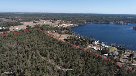 25.4 acres across the street from beautiful Compass Lake located in northwest Florida. This property is wooded and could be the perfect location for your dream home. Homes in Compass Lake in the Hills have access to the clubhouse and amenities that include, swimming pool, tennis courts, picnic areas, fishing, etc. There are two public boat ramps just across the street from this property.  Compass lake is the perfect place for fishing, boating, water sports, swimming, and relaxing enjoying the beautiful views. This lake is busy with motorboats in the summer, but a private oasis in the off season with almost still water reflecting the skies. The lake is a sandy bottom and has clear water. The lake is located almost equal distance from the beaches of Panama City and Dothan, AL.