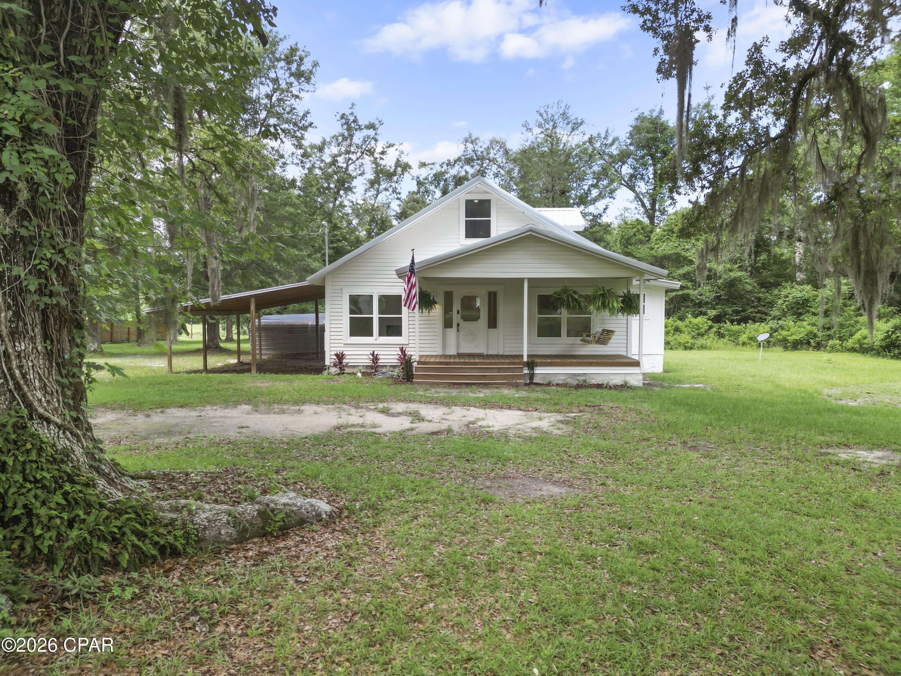 Up for grabs is a freshly remodeled, 3 bedroom 1 bath with a bonus room home, located in rural Grand Ridge, FL. Roughly 1hr to Dothan, AL and Tallahassee, FL. Home is situated on an oversized 1.38+/- acre lot, with paved road access. This beauty features new HVAC, new stainless steel appliances, new low E windows, and much more. Also, offers covered parking and a 8'x21' porch with swing! The beautiful Live Oak trees out front are something worth noting as well! Please set up your showing to see in person, before this one gets gone! All measurements are approximate, please verify if important.
