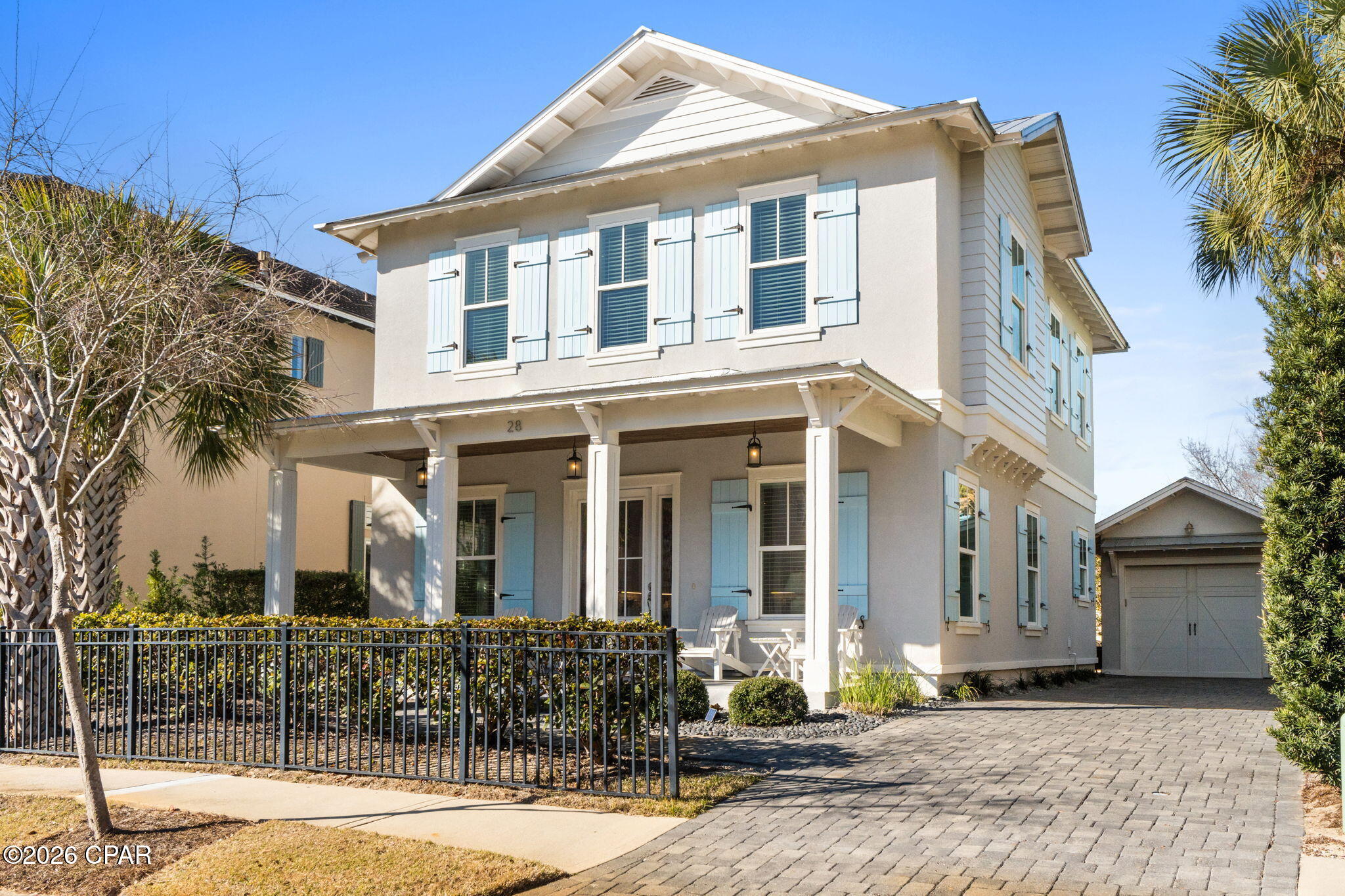 Located within the guard-gated, Gulf-front community of Caribe, this like-new coastal home, built in 2019 and offered furnished, delivers the perfect blend of comfort, style, and relaxed coastal living. Set just a short walk from Caribe's quiet, sugar-white shoreline, the residence offers four bedrooms and four and one-half bathrooms with an open-concept design that seamlessly connects the living, dining, and kitchen areas. Interior finishes include hardwood flooring, shiplap accents, and a well-appointed kitchen with stainless steel appliances, quartz countertops, soft-close cabinetry, tile backsplash, and a spacious center island. The flexible floor plan features primary suites on both the first and second levels, along with a second-floor loft and bunk room ideal for hosting family and guests. Outdoor living is enhanced by a paved rear patio and a rare detached, enclosed garage with a golf cart. Caribe residents enjoy an exceptional lifestyle with two resort-style pools and bath houses, tennis and pickleball courts, a lake pavilion, multiple beach walkovers with professional beach service, scenic sidewalks throughout the neighborhood, courtesy patrol, and a gated entry accented by soft evening lighting and a beautiful streetscape, all just minutes from premier golf, dining, shopping, and popular destinations such as Grand Boulevard, Market Shops at Sandestin, and Silver Sands Designer Outlet.