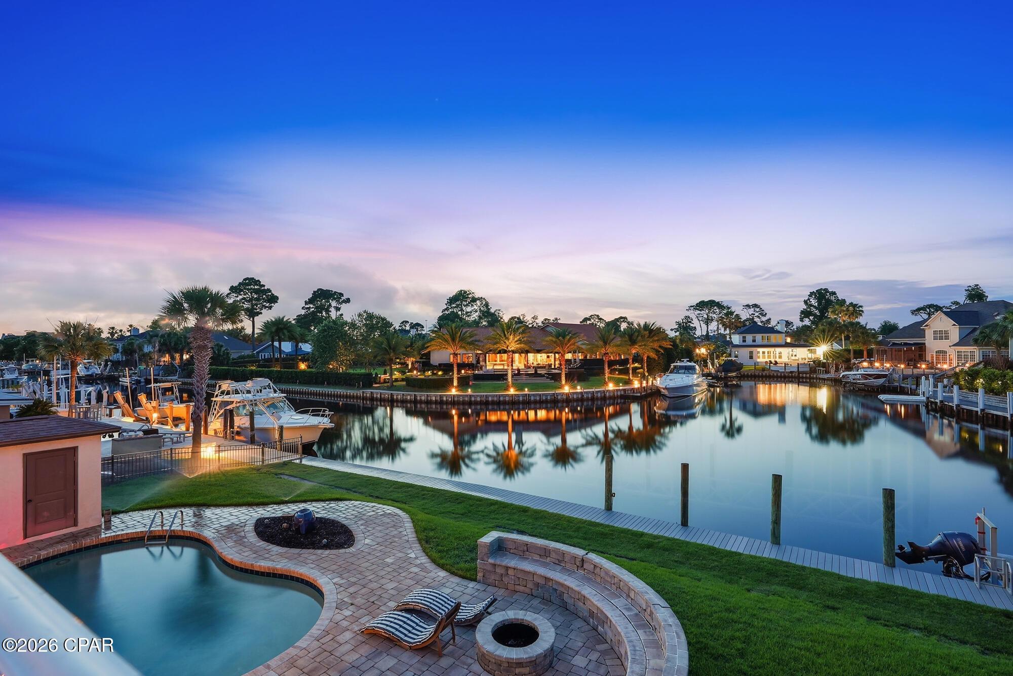 Canal-front living and direct Gulf access define this exceptional residence at 523 Wahoo Road in Panama City Beach. Ideally positioned along a wide canal within the highly sought-after gated community of Bay Point, this 4-bedroom, 3-bath home offers approximately 2,820 square feet designed for relaxed coastal living and effortless boating convenience.

The main living spaces are thoughtfully oriented to capture tranquil water views, with expansive windows and seamless access to the outdoor entertaining areas. A spacious design connects both living rooms, dining area, and kitchen, creating an inviting atmosphere ideal for both everyday living and entertaining. The distinctive sunken living rooms add architectural character and warmth, offering a comfortable gathering space with timeless appeal.

The kitchen provides generous counter space, ample storage, and a functional layout suited for everything from casual mornings to hosting family and guests. The primary suite is privately situated away from the secondary bedrooms and features water views, generous closet space, and an en suite bath designed for comfort and privacy.

Three additional bedrooms and two full baths provide flexibility for guests, a home office, or additional living space, making the home equally suited as a primary residence or coastal retreat.

Outdoor living is central to the experience of this property. The canal-front setting offers direct access to the Gulf of Mexico, making it ideal for boating, fishing, and exploring the surrounding waterways. The outdoor space provides room to relax, dine, and enjoy the peaceful waterfront setting year-round.

Located within the established marina community of Bay Point, residents enjoy gated security, golf, tennis, nearby dining, and convenient access to the beaches and amenities of Panama City Beach, all while maintaining the privacy and tranquility of waterfront living.

523 Wahoo Road presents a rare opportunity to enjoy spacious canal-front living with direct Gulf access in one of Panama City Beach's most established coastal communities.