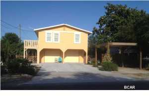 You've found your beach house with room for all of your toys! Close to the beach, minutes to Pier Park and centrally located to schools. New flooring, metal roof, alarm system, new appliances, and more! Three bedrooms and two full baths on the spacious upper level. Two car garage and updated rental ready 1BR/1BA apartment (Mother-in-Law Suite) with kitchen and living room on ground level and sliding glass doors to an outside patio. Plenty of room for parking and outdoor entertaining in this piece of paradise. Relax and enjoy the low maintenance gardens, privacy fenced back yard with sprinkler system. Great opportunity for first or second home, or investment property. Potential gross rental income of $2,000/month. All information is believed to be correct but should be verified by Buyer.