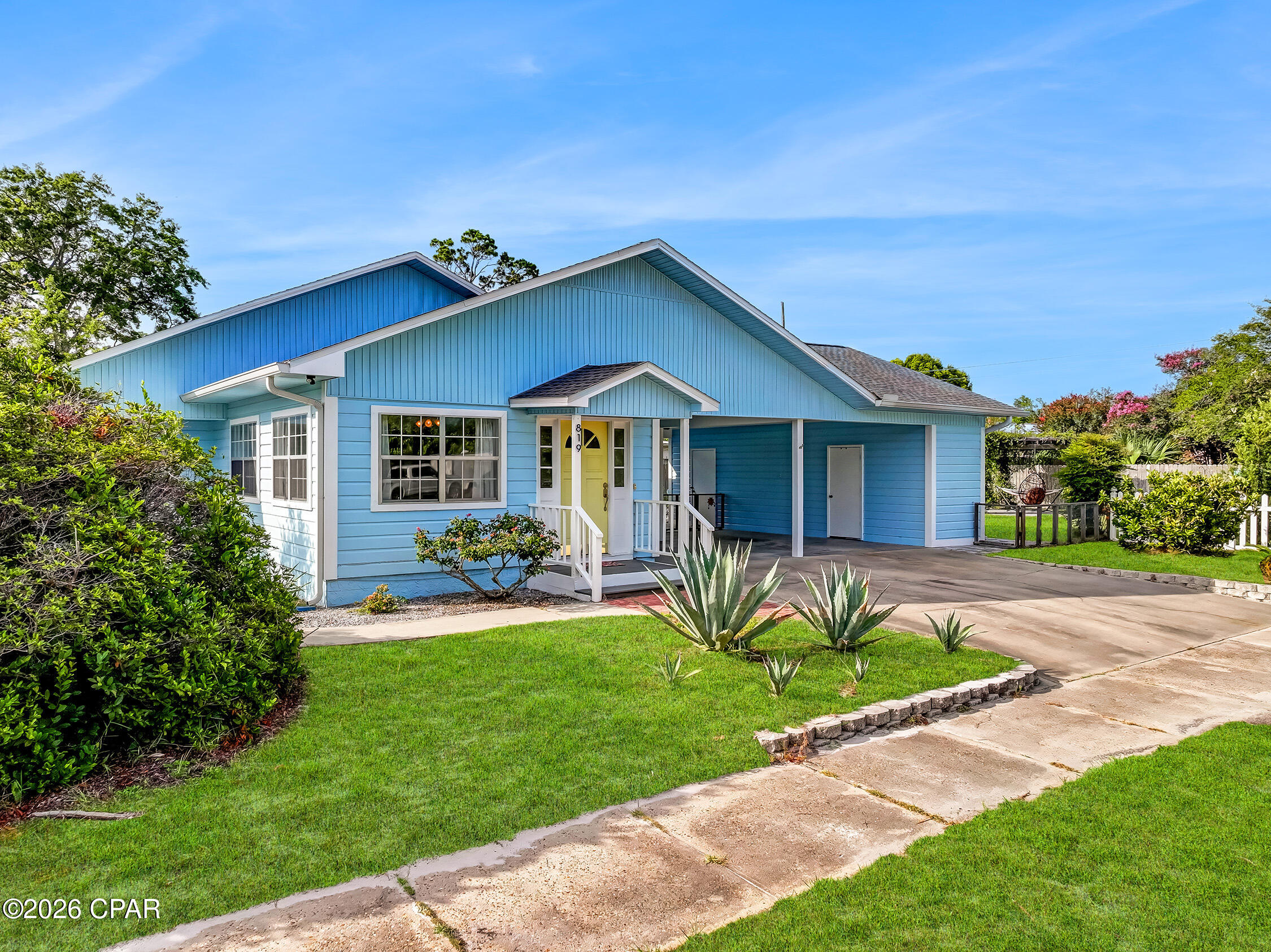 FEEL AT HOME in this bright and cheery Florida cottage. This 3 BR, 2.5 BA home sits on almost a third of an acre in the center of Port St. Joe, just blocks away from both the area schools and the St. Joseph Bay. This home has all the charm with hardwood floors, tongue and groove walls/ceilings. House has been recently painted inside and outside so you have low maintenance. After a day of exploring the downtown boutiques, shops, and restaurants, come home and relax in your beautiful park-like backyard with paver patio and walkways, or enjoy some peace and quiet in one of your two living areas. Entertaining is easy in a kitchen with plentiful cabinets, a built-in oven, and a pass-through window between kitchen and dining room. Covered parking for 2 vehicles sits under the breezeway between the home and workshop/storage area. Call today for your chance to own a super unique home in the heart of PSJ.