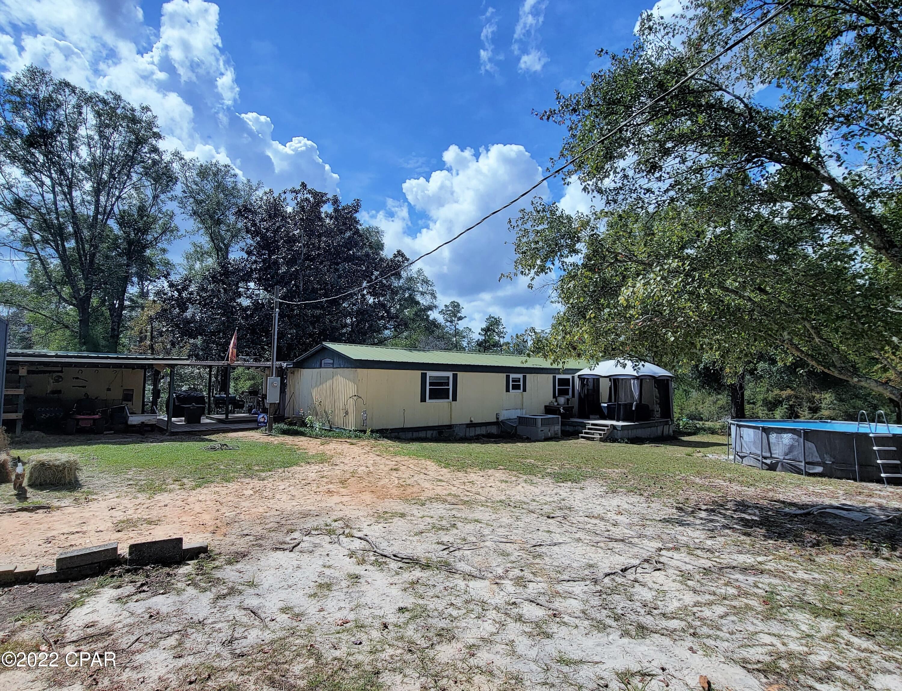 Get away from it all and escape to the country!!!! If you are looking for a mini-farm, you've found it.  Add a gate to the entrance and the property will be completely fenced and cross fenced.  This parcel features a mobile home with an addition, new appliances, new meter box and power pole, multiple outbuildings, a storm shelter, a horse stable with fencing, a shipping container, chicken coop and pig pen.  Relax on the patio and enjoy nature in a peaceful setting.  Contact your favorite realtor for your showing before it is gone!