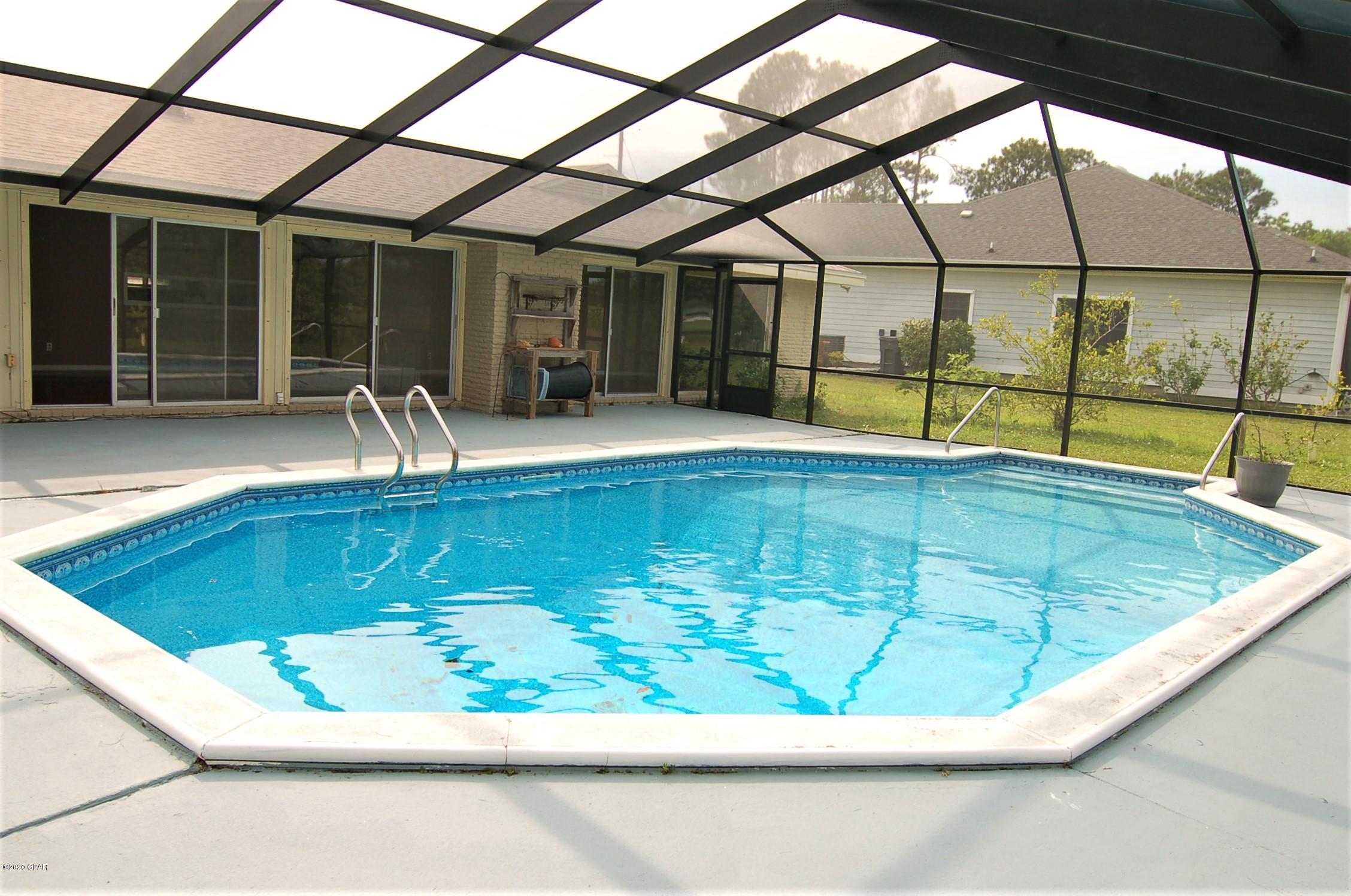 CURRENTLY UNDER CONTRACT, SELLER ACCEPTING BACKUP OFFERS' This home is a MUST SEE. Located in the highly desirable Colony Club subdivision which is one of Panama City Beaches most sought after neighborhoods. This home is located on the 1st fairway of the Holiday Golf Course. The expansive living and dining area has not 1, not 2 not 3 but 4 sets of large sliding doors to the 36 x 20 pool and golf course.The new $25,000 pool enclosure was just added on April 15, 2020. There is a 5th set of sliding doors in the master bedroom that also leads to the pool and golf course. This 3 bedroom 2 bath home  from the back faces East so you get the full early morning sunrise views. Click on ''more'' to get further information on this home. This home is in a fantastic school district. You will be about 10 minutes to the sugar white sands of Panama City Beach, restaurants and great shopping at Pier Park. Recent updates include a new roof, new energy efficient water heater, new air conditioner system inside and out, dishwasher, windows and gutters over the front door
