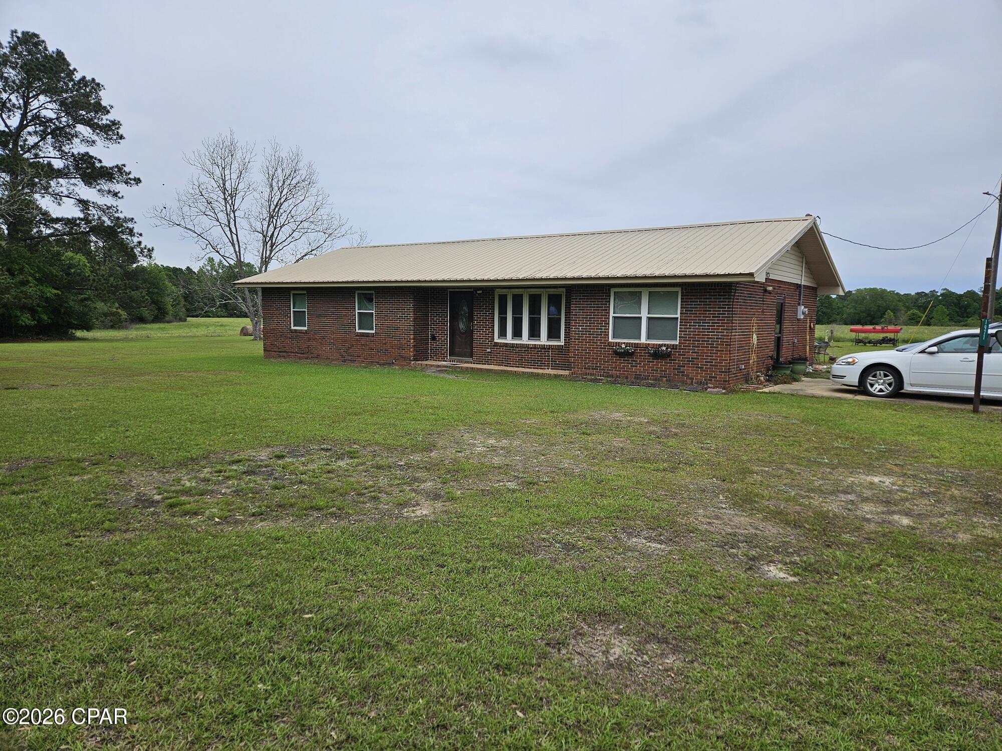 Very nice well kept home on a large private lot. A modest 3 bedroom home that has been very well taken care. Newly remodeled main bathroom as well as newer Kitchen cabinets and bar counter. Spacious living room and additional smaller den room. clean well built brick home with newer metal roof. Perfect starter home for a couple with 3 bedrooms with private master bath.  Very nice wooded additional acres leaving lots of opportunity for additional family member homes or possibly sell an acre or two to generate some extra cash. great spot just 10 minutes to Bonifay and I-10. Probate currently being conducted so possession might be a few months out. Nice large outdoor shed for what ever the new buyer desires. Interior and additional exterior pictures should be available in a week or so.