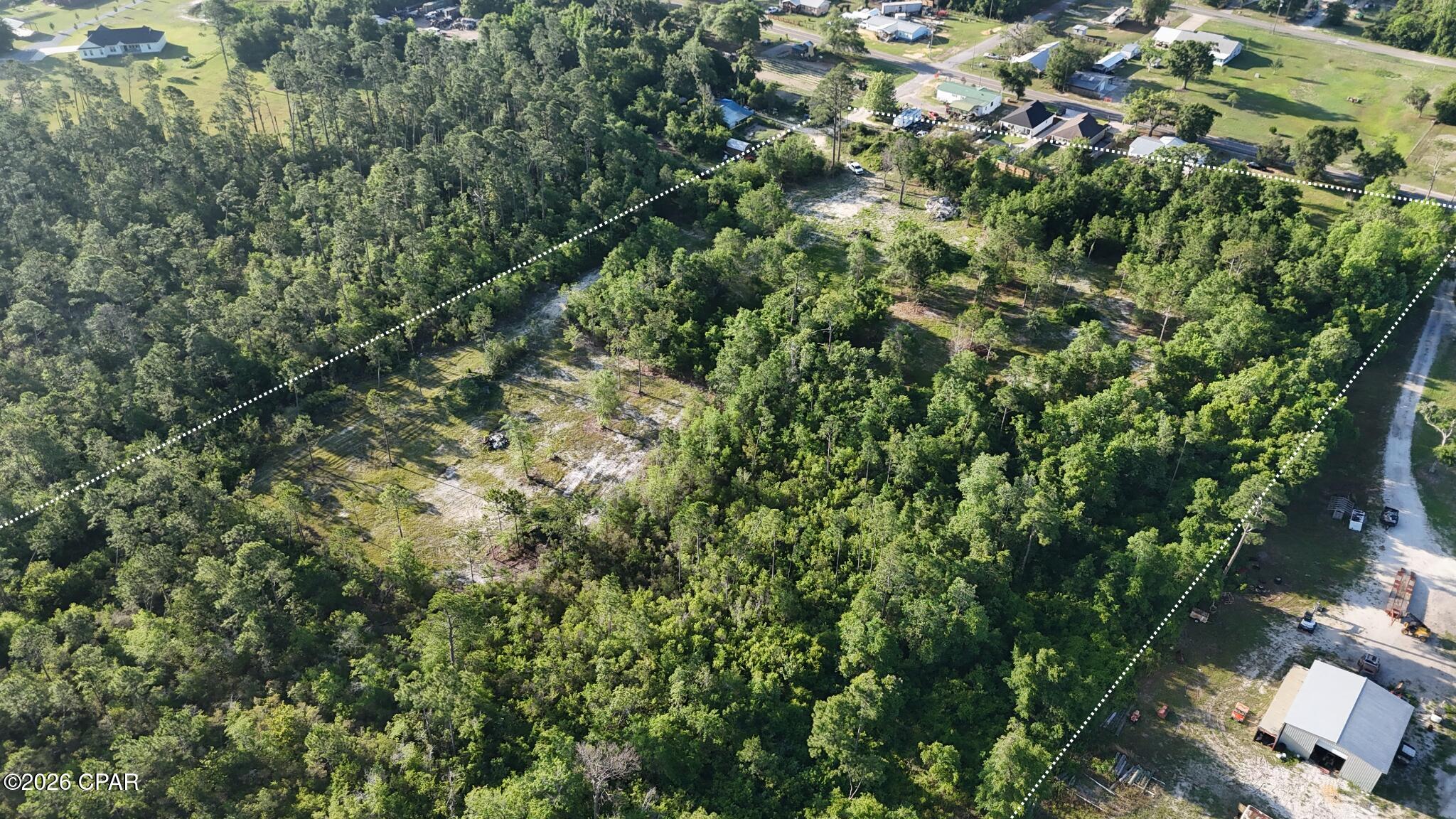 RARE SOUTHPORT OPPORTUNITY! Prime 8-acre parcel located in the heart of the rapidly growing Southport area, offering endless potential for development, investment, or your private estate. Properties with this much usable acreage, existing improvements, and development flexibility are becoming increasingly hard to find in North Bay County.

This property has already undergone major improvements, saving buyers both time and expense. The previous home has been removed, creating a clean slate ready for your vision. A culvert has been installed, providing improved access throughout the property and opening the door for multiple uses. The existing layout offers the potential for two buildable lots as-is, with additional room for future development opportunities.

A scenic creek runs through the property, adding natural beauty, privacy, and character rarely found on parcels this size. An existing barn remains on-site and could be repurposed for storage, workshop space, agricultural use, or future improvements.

Conveniently located just minutes from Panama City, schools, shopping, and area amenities while still offering the peaceful feel of country living. Whether you're looking to build, develop, invest, or secure land in one of Bay County's fastest-growing areas, this is a rare opportunity you do not want to miss.

Seller is motivated so bring all offers!