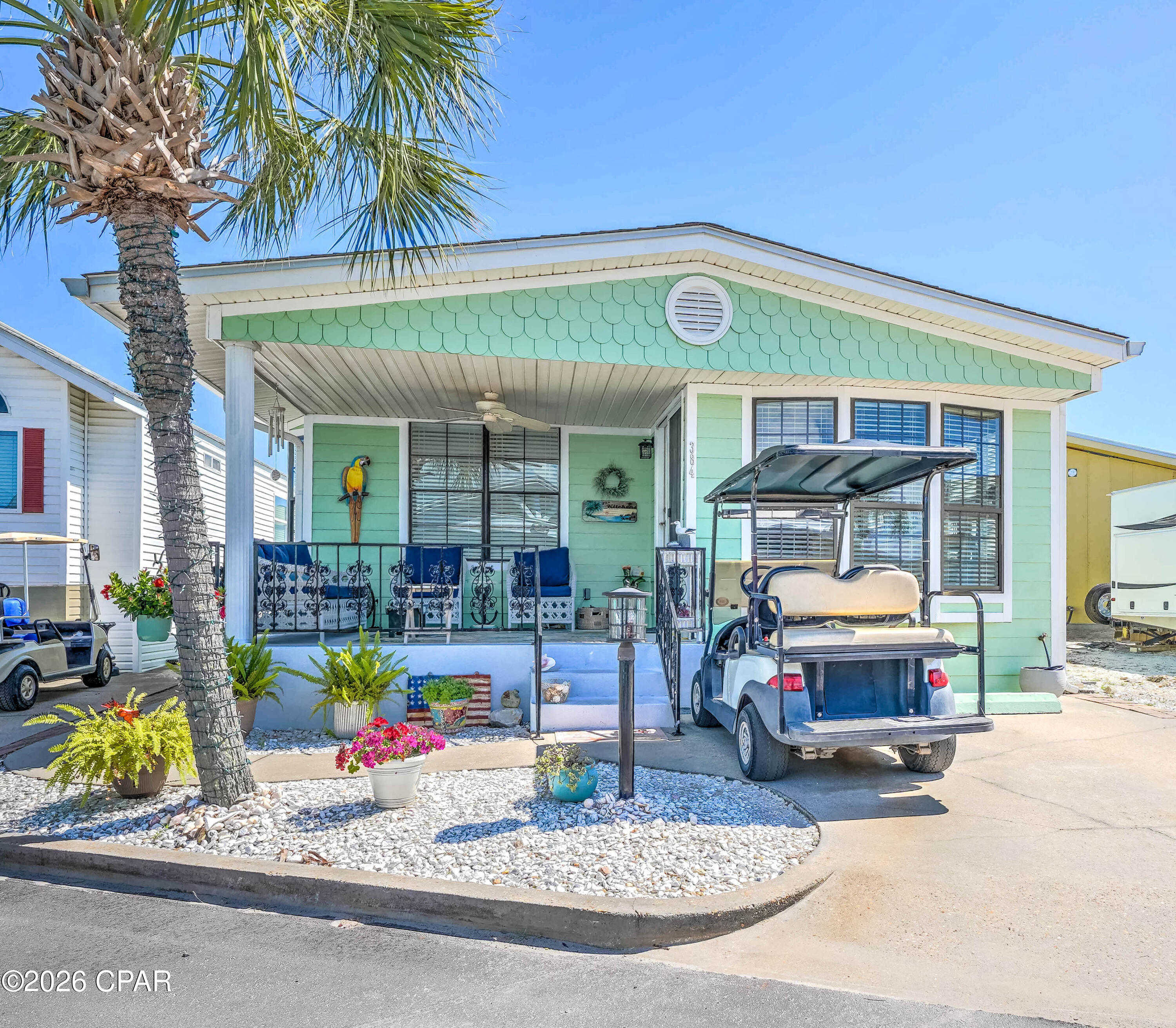 Welcome to your slice of paradise in Venture Out -- one of Panama City Beach's most desirable gated golf cart communities with private beach access! This beautifully maintained 2-bedroom, 2-bath home is the perfect beach retreat or second home and although this home has never been used as a rental property, it offers excellent potential as an income-producing investment opportunity. From the moment you arrive, you'll fall in love with the charming curb appeal, tropical landscaping, and the AMAZING oversized front porch that is ideal for relaxing, entertaining, or enjoying the coastal breeze.

Inside, the home offers a light and airy coastal feel with numerous updates throughout, including new flooring, fresh paint, a newer HVAC system, a new roof, and new seamless gutters. The spacious living area flows into the updated kitchen featuring beautiful countertops, ample cabinet space, and an open layout perfect for gathering with family and friends.

This home is being sold furnished and even includes a golf cart, making it completely move-in or rental ready. Whether you are looking for a personal beach getaway or a strong vacation rental opportunity, this home checks all the boxes.

Located in Venture Out, residents enjoy resort-style amenities including private beach access, 2 pools, tennis courts, fishing pier, boat ramp, playground, and 24/7 gated security -- all just steps from the sugar-white sands of the Gulf of Mexico. Don't miss this opportunity to own a piece of paradise in Panama City Beach!
