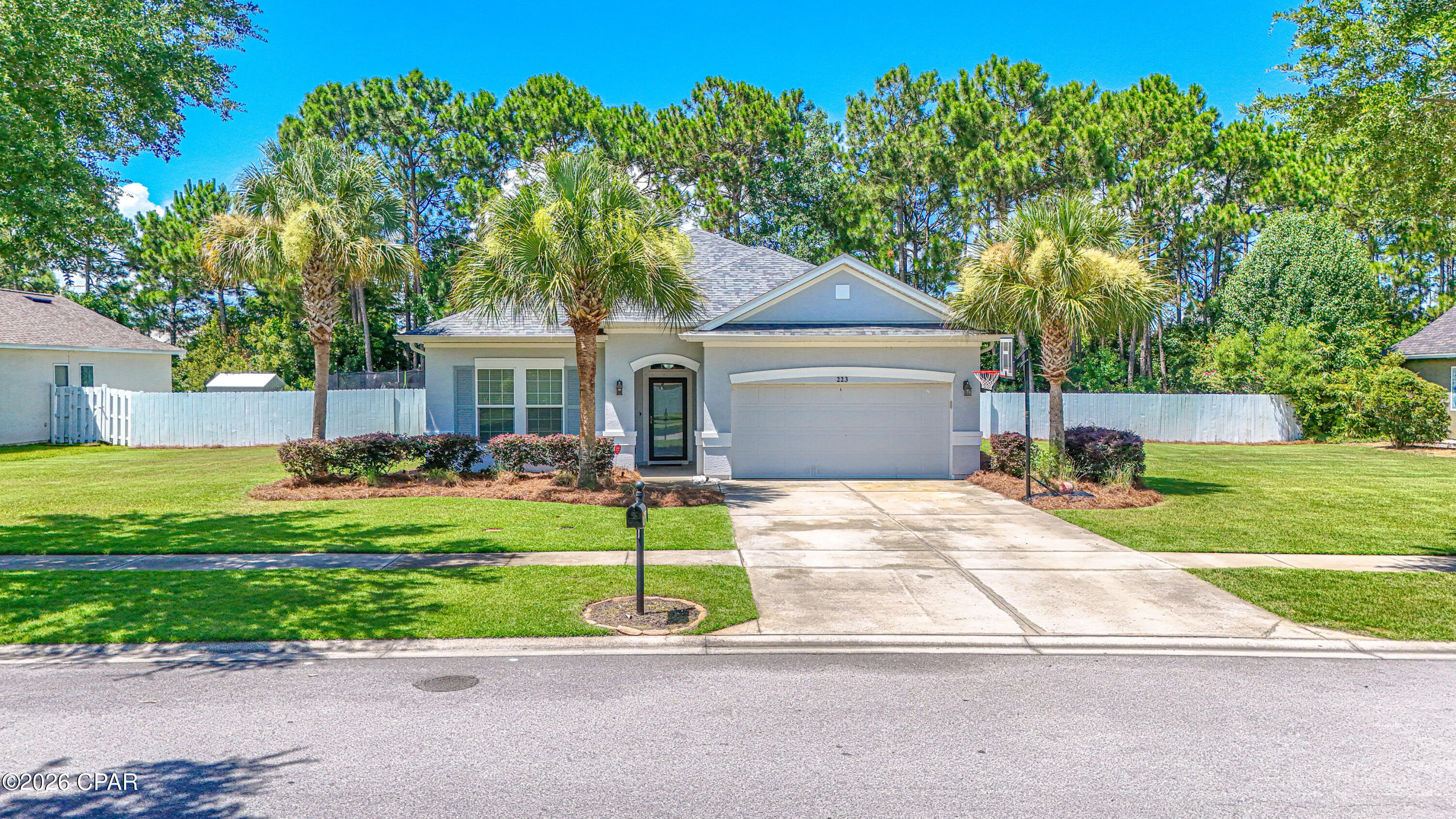 Newly renovated and move-in ready, this beautifully updated 3-bedroom, 2-bath home in the highly sought-after Phase IV of Palmetto Trace offers 1,610 square feet of stylish, functional living space just minutes from the white-sand beaches of Panama City Beach. 

Recognized as one of the more desirable floor plans built by David Weekley Homes, this thoughtfully designed residence offers an exceptional blend of comfort, functionality, and coastal style.  

Situated on one of the few double lots in the neighborhood, this property offers an exceptional amount of space, added privacy, and room to breathe between neighboring homes. The expansive lot backs up to a mature-wooded area, creating a private backyard setting and a rare sense of seclusion within the community. The generous lot provides incredible flexibility for future possibilities, including potential home expansion, additional outdoor living areas, or the addition of a private pool, making this a truly unique opportunity within the neighborhood. The home also features a convenient two-car garage, providing ample space for vehicles, storage, and beach lifestyle essentials. 

Step inside to discover an inviting open layout featuring luxury vinyl plank flooring throughout the main living areas, kitchen, bathrooms, bonus room, and primary bedroom, creating a seamless, modern feel throughout much of the home. The two additional bedrooms are comfortably carpeted and thoughtfully positioned near the second bathroom. The home features impressive 10-foot ceilings throughout, including the garage, creating an open and spacious feel rarely found in many homes of this size. 

At the heart of the home, the recently renovated kitchen showcases elegant quartz countertops, stainless steel appliances, abundant cabinetry, and a functional layout that is perfect for everyday living and entertaining.  

A standout feature of this home is the renovated bonus room, offering a versatile flex space that can easily serve as a home office, playroom, media room, fitness area, or second living space. Filled with natural light, this room features an energy-efficient ductless mini-split heating and air conditioning system, providing year-round comfort with independent climate control. 

Designed with a desirable split-bedroom floor plan, the spacious primary suite is situated away from the two additional bedrooms, creating both a comfortable and private retreat. The primary suite features luxury vinyl plank flooring, an en-suite bath, and a generous walk-in closet, while the secondary bedrooms provide comfortable accommodations for family and guests. 

This charming community welcomes residents with tree-lined streets shaded by mature oak trees, beautifully maintained sidewalks, two community swimming pools, low HOA dues, and a golf cart-friendly neighborhood. With two convenient community entrances, accessing nearby destinations is simple and convenient. Enjoy easy access to popular Panama City Beach attractions including Pier Park, Frank Brown Park, Gayle's Trails, Topgolf, and Pirate's Voyage Dinner & Show, along with premier shopping, dining, entertainment, and the emerald waters of the Gulf. 

Whether you're looking for a full-time residence, a vacation getaway, or an investment opportunity, this turnkey home delivers modern renovations, a highly sought-after David Weekley floor plan, impressive ceiling heights, flexible living space, a rare double lot with privacy, and an exceptional coastal location. Don't miss your chance to make 223 Middleburg Drive your own!