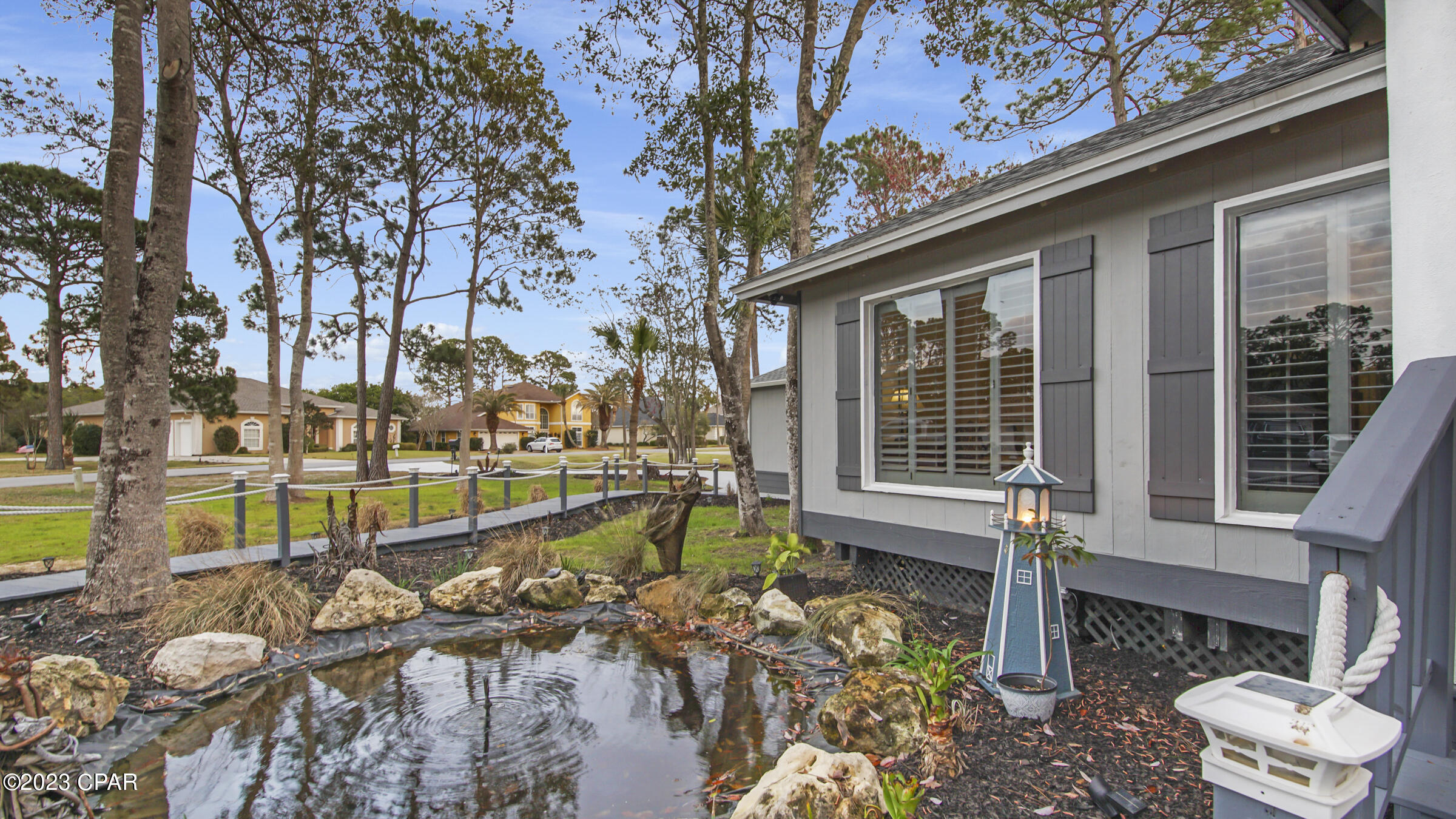 CURRENTLY UNDER CONTRACT, SELLER WILL CONSIDER BACKUP OFFERSBeautiful custom home nestled on an extra large lot in the well established neighborhood of the Glades. You can stroll up the lighted boardwalk to the front door or enter through the kitchen by the garage. The grand living room features 18 foot ceilings with new skylights surrounded by wood inlay and easily illuminated at night for lovely ambiance. There is a wet bar and plenty of room for a large TV. The renovated kitchen features all new appliances, quartz countertops, LVP flooring and stainless single basin sink. The living room, kitchen and master bedroom feature large windows with plantation shutters overlooking the stunning  pool and outdoor living area. The dazzling pool is completely screened in and enclosed making it feel New roof, a/c, pool filter, pool heater and new exterior paint. The detached two car garage is oversized with a high ceiling offering plenty of room for storage. This home is truly unique, beautiful and less than a mile to the gorgeous beaches. Call for your private showing today!