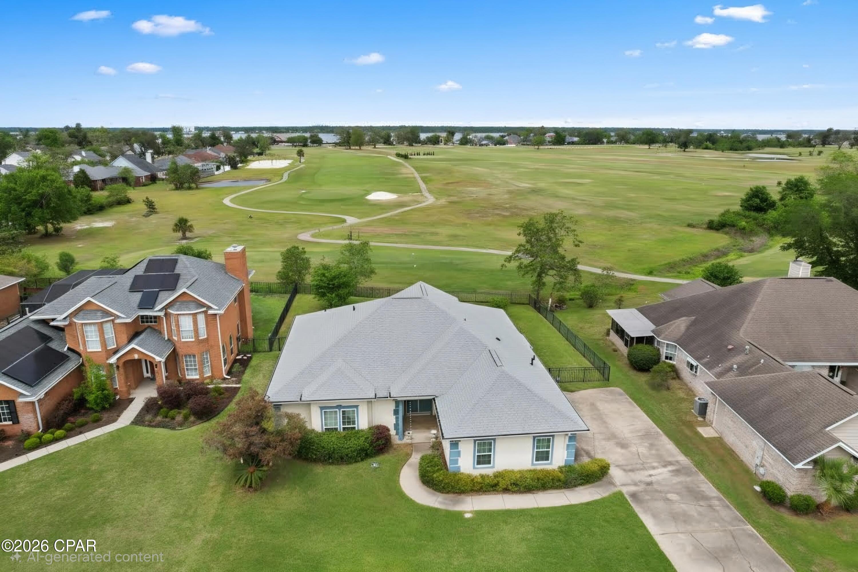 Welcome to this Lynn Haven traditional 4-bedroom, 2.5-bathroom home with a desirable split floor plan, perfectly positioned overlooking the 2nd tee box of Panama Country Club.

As you enter through the double doors, you're welcomed into a bright and spacious living room featuring high ceilings, abundant natural light, and a cozy corner fireplace. Just off the main living area is a sunroom with beautiful views of the backyard, along with a formal dining area that flows into the kitchen.

The kitchen is equipped with stainless steel appliances, a center island, and ample cabinet storage, plus sliding glass doors that provide easy access to the backyard, enclosed with a wrought iron fence.

The primary suite is generously sized and located on one side of the home, offering a recently updated bathroom with double vanities, a soaking tub, and a separate shower. On the opposite side, you'll find three additional bedrooms and a full bath, providing privacy and flexibility for family or guests.

Enjoy golf course living in a well-established community. Panama Country Club features an Donald Ross 18-hole course, along with optional membership amenities including a bayfront clubhouse, dining, fitness center, pickleball courts, and bayfront pool. Buyer to verify any information deemed important.