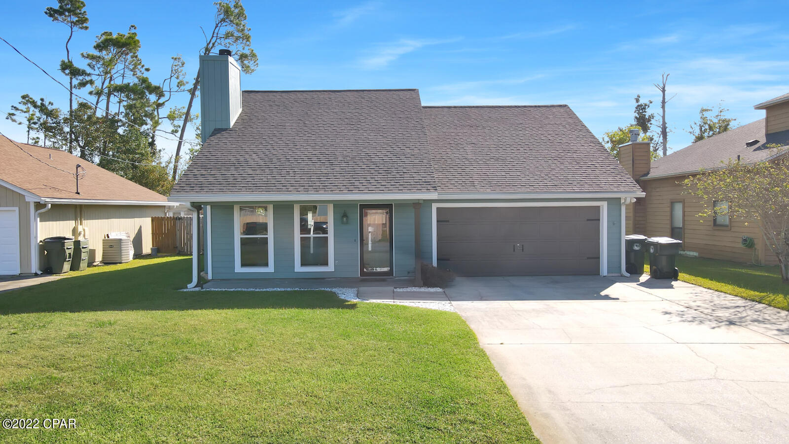 MOTIVATED SELLER! Beautiful home in Lynn Haven. Renovated 4 bedrooms, 2.5 bathrooms. New roof, new doors, new windows, new carpet and LVP flooring in living and kitchen. Freshly painted! Stone fireplace. The kitchen features granite countertops, hardwood cabinets, and stainless appliances. The downstairs master bedroom is large and features an ensuite bathroom with tiled shower/tub, a double vanity, and large walk-in closet. 2nd bedroom is also downstairs. The upstairs features 2 additional bedrooms, or 1 bedroom and a bonus room. They upstairs bedrooms share Jack and Jill bathroom. The home is wired for a pool/hot tub, and features a privacy fence. Protected land behind the home ensures privacy. Home is offered with a 1-year home warranty.