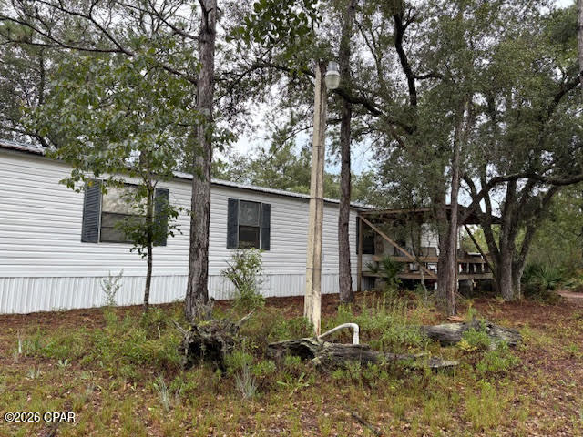 Looking to start a family compound? Here's the perfect beginning! This 10-acre property features a 2-bedroom, 2-bath single-wide mobile home located at the front corner, with ample space to add additional homes for your family. The mobile home is move-in ready, complete with a metal roof, a brand-new HVAC system (installed July 2025), and comes fully furnished, as-is. A large pole barn is set up to accommodate your RV -- just plug in the power and connect to the water and septic. Two separate, secure storage containers provide extra space, with one featuring lights and power. The property is easy to navigate with marked corners and a perimeter you can walk or drive. It's high and dry, ensuring excellent drainage. A short drive takes you to the public library and volunteer fire department, while less than an hour's drive gets you to Panama City and its beautiful beaches, shopping, dining, and entertainment. The possibilities are endless -- whether you want to keep the land wooded, plant a garden, add fruit trees, raise animals or horses, or simply enjoy the abundant wildlife, including deer that roam the woods. This property offers the space, privacy, and potential for your family's future.