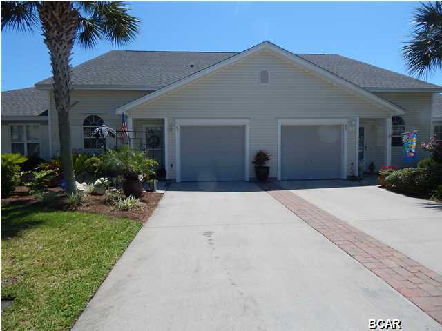 Great location across the street from Pier Park and less than 2 miles to the beaches, restaurants and shops. This unit is one of the largest attached at 1837 sq ft. Home sits on the pond and you do not have to worry about neighbors behind you, thus giving you additional privacy. Sellers have spent over $40,000 in remodeling and improvements. $13,000 was spent on new custom Pergo hardwood flooring which comes with 16 year warranty. Hardwood flooring is throughout the entire home. Kitchen is large, with an open floor plan and breakfast bar. New Corian counter tops. As you walk into the entrance, you are greeted with the long hallway foyer. The master bedroom is on the first floor and has the his and hers closets. Walking up the second floor, you have a large 10X13 loft as a hangout for