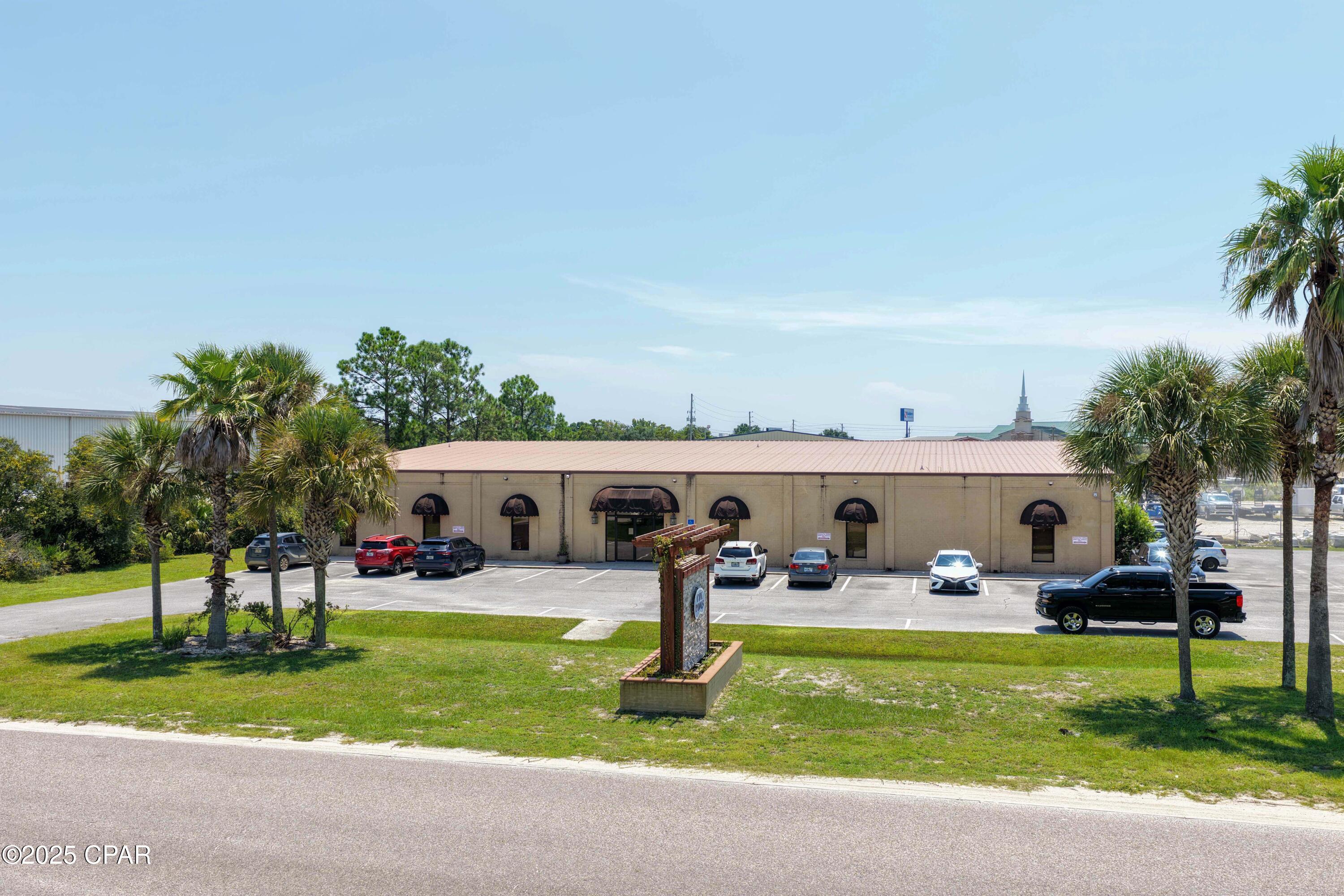 ' Owner financing available' Rare opportunity to acquire a premier commercial/industrial property in Beach Commerce Park on the West End of Panama City Beach. Situated on 3.9± acres, this property offers a powerful combination of office, warehouse, and outdoor storage space in one of the area's only planned industrial parks.



The improvements include 6,820 sq. ft. of professional office space and a 24,400 sq. ft. warehouse, providing ample room for administration, storage, distribution, or manufacturing operations. In addition, the site features an approximate 1.9-acre lay-down yard ideal for equipment staging, materials, or outdoor operations. Designed with functionality in mind, the property has ample parking and direct access for 18-wheelers and heavy equipment, making logistics and transportation seamless.



Beach Commerce Park is a fully serviced development with public underground utilities, recorded covenants, and design standards that ensure a consistent, high-quality setting for businesses. Located just off Panama City Beach Parkway (U.S. Hwy 98), approximately one mile west of Highway 79, the site provides excellent connectivity east and west along the Parkway, as well as quick access north to Interstate 10 and Northwest Florida Beaches International Airport.



With Panama City Beach's West End continuing to grow, this property stands out as a one-of-a-kind industrial opportunity. Its scale, versatility, and prime location make it ideally suited for a large construction company, distribution hub, or any enterprise needing significant office, warehouse, and yard space in one of the region's most strategic corridors.