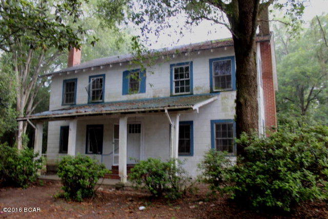 PRICE REDUCED!! Have you ever wished for 5 bedrooms? Well, this house has them! You also have 5.28 acres of land just on the outskirts of town. The house is 2 story with a formal living room, formal dining room, kitchen and 2 bedrooms downstairs. Upstairs you have a large sitting room and 3 more bedrooms. The lot is large with room for animals, chickens and even a garden. There is a chain link fenced back yard for pets and the front of the property has chain link fencing. The lot is shaded with magnolias, oaks and pecan.