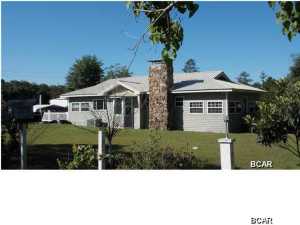 SPECIAL PEOPLE FOR A SPECIAL PLACE. If you love being outdoors and keeping busy while living the country life, then you will really like living here. Quaint updated farm home in rural setting for horses or a hobby farm. Land includes apple, peach, plum, pear trees, grapevines, blueberry and fig bushes, fish pond with dock, chicken coup and dog pen. Additional parcel next to home that is fenced/gated .89 acre for horses at $22000 and.72 acre across street with large RV building and 20x20 metal building for $26000. One or both of these additional parcels can be owner financed. You can buy home with 2 acres for $100,000 and also buy any parcel or combination of any of these parcels. Just make offer on combinations. All property is fenced with several gates for horses or to separate