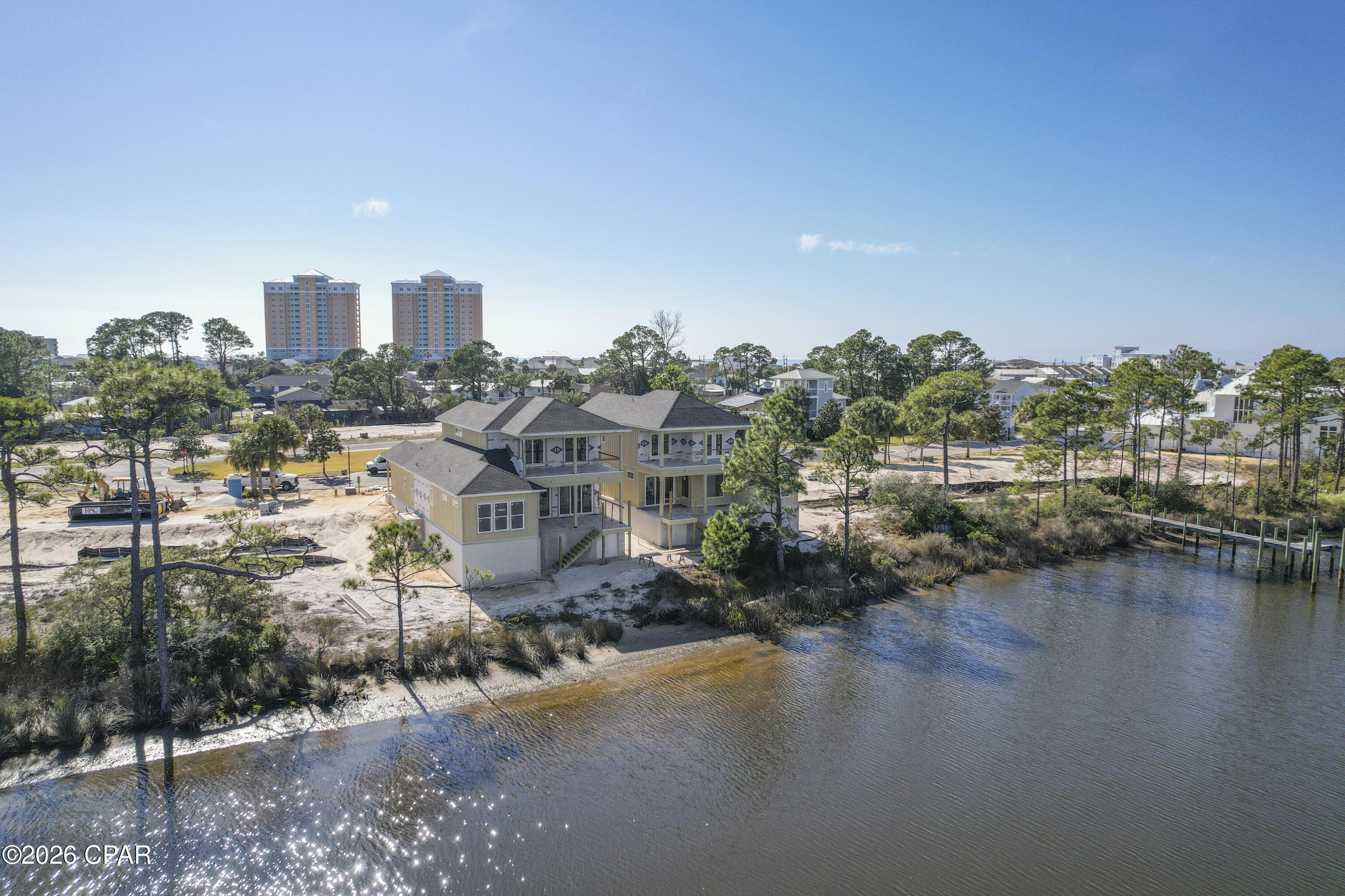 LAGOON LIVING now UNDER CONSTRUCTION. Home will have dock and boat slip (refer to site map rendering). The new homesites in the gated Grand Lagoon Pointe will offer waterfront and interior sites. Waterfront homes will include dedicated docks for boating access from Grand Lagoon directly to the Gulf of Mexico. Less than one mile to Rick Seltzer Park. All homes will have access to the community pool and green space. 
This Lot 6 Dolphin plan will host 3 bedrooms and 3 full bathrooms with a gameroom or additional bedroom. The downstairs master bedroom will have beautiful views of Grand Lagoon as well as water front views in two upstairs bedrooms. Drink your coffee on the covered patio while watching the dolphins play. 
Constructed to be completed Spring 2026.
