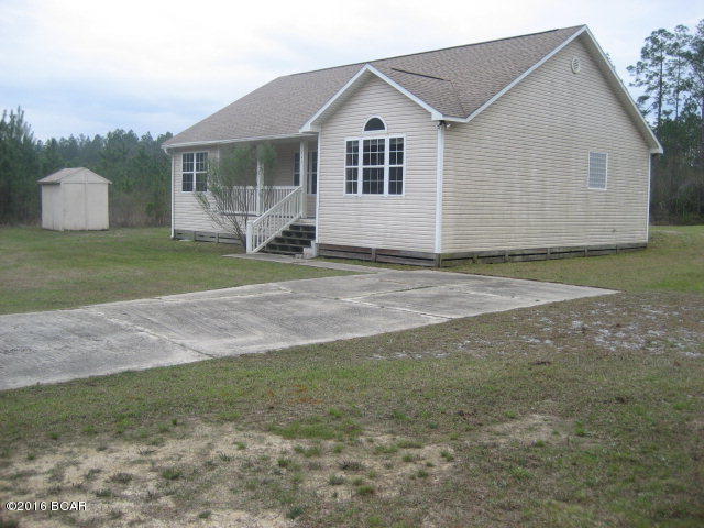 $79,900. BANK-OWNED PROPERTY IS BEING SOLD AS IS, WHERE IS, WITH ALL FAULTS. This 2005 frame home with vinyl siding sits on 1.196 acres of cleared land, with paved road frontage in the country. Located approximately 15 minutes (12 miles) from the Gulf of Mexico, and just 9 miles (10-12 minutes) from Wewahitchka. With 1,404 heated sq. ft. (1,724 total sq. ft.), this home has 3 BR's, 2 baths, living room, dining room, kitchen, and laundry/utility room. The floors throughout are ceramic tile. Master bathroom has garden tub and separate shower. The master bedroom, living room, and dining room have vaulted ceilings. The inside central heat/air system is present, but the outside condenser unit is gone. There is some minor wood rot around the back door that will also need repair. The submergible pump from the well is also missing and will have to be replaced. $79,900.