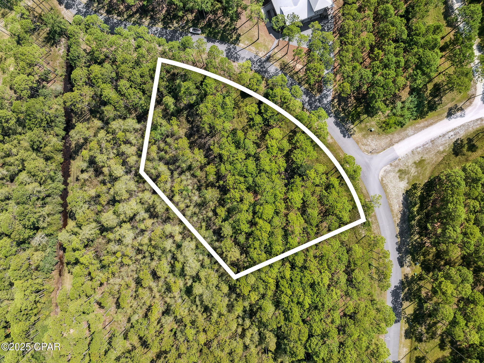 Tucked inside the private, gated community of RiverCamps, this .61-acre homesite sits on a paved road just a quarter mile from West Bay, perfect for enjoying refreshing coastal breezes. RiverCamps is a hidden gem in Panama City Beach, thoughtfully designed as a 1,500-acre nature preserve. With fewer than 450 homesites placed across 500 acres and the remaining 1,000 acres dedicated to conservation, it offers a rare balance of privacy and natural beauty.

Residents enjoy over 7 miles of scenic trails for hiking, biking, and wildlife watching, along with direct access to West Bay, Crooked Creek, and the Intracoastal Waterway. The community also features a private boat ramp and dry storage, making it easy to get on the water and reach Shell Island or the Gulf in about 30 minutes.

Conveniently located just 10 miles from the sugar-white sand beaches of the Emerald Coast and only a short drive to Northwest Florida International Airport, RiverCamps blends convenience, privacy, and an exceptional outdoor lifestyle.