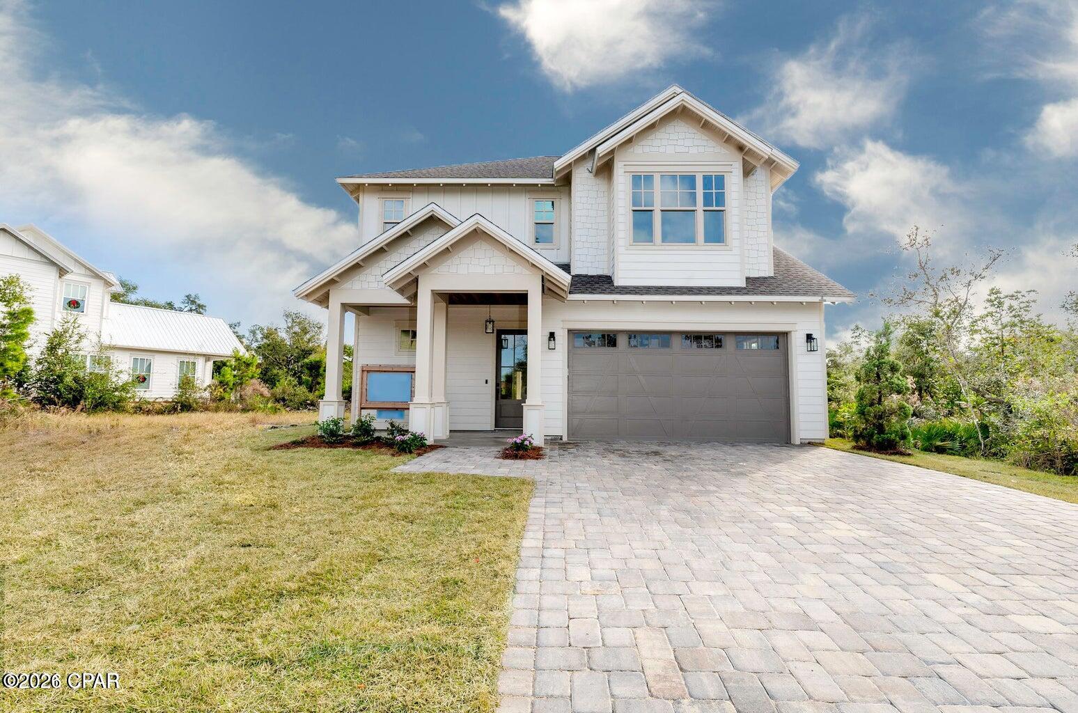 LOWEST PRICED PER SQUARE FOOT CUSTOM HOME IN SANCTUARY BEACH!

Beautifully crafted and impeccably maintained, this 4-bedroom Craftsman home in the highly sought-after Sanctuary Beach subdivision offers the perfect blend of timeless design, modern upgrades, and coastal convenience. Move-in ready and thoughtfully enhanced throughout, this residence delivers both comfort and sophistication in a serene, wooded setting.

Ideally positioned within the community, the home is just moments from the neighborhood pool and approximately ¼ mile to the nearest beach access, making it easy to enjoy the best of the Emerald Coast lifestyle.

Inside, the open-concept floor plan is filled with natural light and elevated by white oak flooring, soaring ceilings, and expansive windows. The chef's kitchen is a true centerpiece, featuring white cabinetry, marble countertops, a shiplap and cedar backsplash, breakfast bar, upgraded stainless steel appliances, and a ZLINE commercial-grade range with six gas burners, electric oven, and vent hood. A spacious butler's pantry adds both function and style.

The main living and dining areas are designed for effortless entertaining, highlighted by a vaulted ceiling and 8-foot folding French doors that open to an oversized patio and backyard perfect for seamless indoor-outdoor living.

The main-level primary suite offers a private retreat, complete with reclaimed 9-foot barn doors, a spa-inspired bathroom with marble flooring, a large glass-enclosed shower, double vanities, a freestanding soaking tub, and an expansive custom walk-in closet.

Upstairs, you'll find three generously sized bedrooms, a full bath with tiled tub/shower and double vanity, and a spacious laundry room with additional storage and natural light. A convenient powder room is located on the main floor for guests.

Additional features include full insulation of all interior and exterior walls, blown-in ceiling insulation for enhanced energy efficiency, a paver driveway, and an attached two-car garage.

Located near a Jack Nicklaus-designed golf course, multiple marinas, St. Andrews State Park, and an array of dining and entertainment options, this home offers both tranquility and accessibility.

This exceptional property captures the essence of Sanctuary Beach living, schedule your private showing today.
