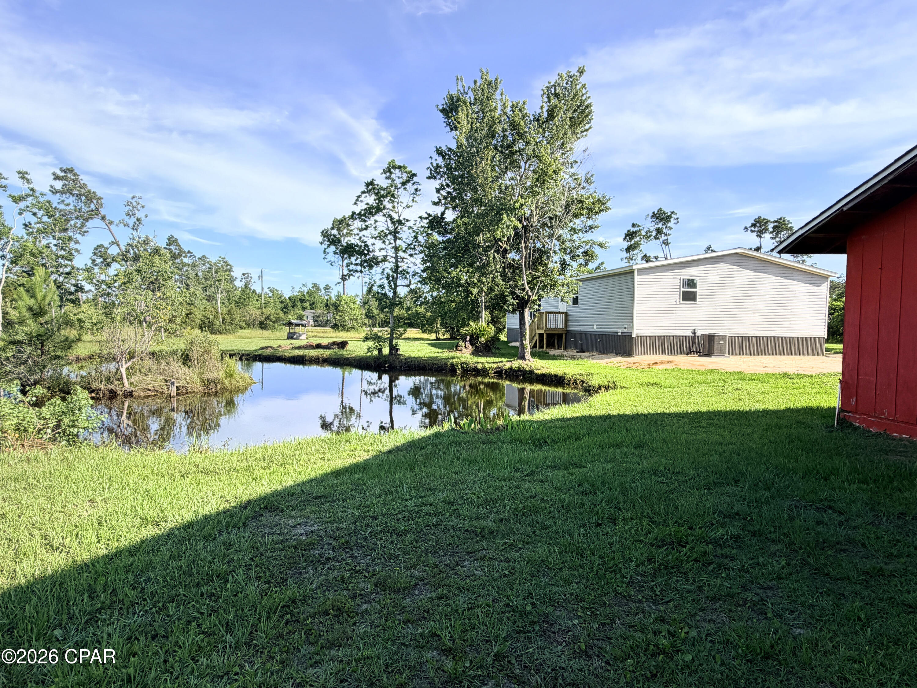 The area is known for being tranquil and ''equestrian-friendly,'' . Located in a quiet, rural-residential neighborhood characterized by large, multi-acre lots. This new Clayton home is situated on 2.5 acres there is a pond and barn. 

Experience the perfect harmony of contemporary design and rural tranquility with th''The Discover'' model, perfectly situated on a sprawling 2.5-acre double lot. This isn't just a home; it's a lifestyle retreat featuring its own private pond and a functional horse barn, ideal for equestrian enthusiasts or those seeking a peaceful escape or great space for hobbies like automotive restoration.

The Home: Boasting an extra-wide 32' footprint, this 1,680 sq. ft. offers a masterclass in open-concept living. The heart of the home is a chef-inspired kitchen featuring 42'' Duracraft overhead cabinetry, a sleek European-style range hood, and a massive central island perfect for entertaining. Natural light pours through oversized 60'' Thermopane Low-E windows, illuminating the 8-foot flat ceilings and modern finishes throughout..

Flex Space: A dedicated area off the living room serves as the perfect home office, gym, or playroom.

Primary Retreat: Relax in the spacious master suite featuring a large walk-in closet and a spa-like ''glamour'' bath with a fiberglass garden tub and dual porcelain sinks.

Functional Mudroom: A high-capacity utility room with extra shelving makes country living organized and easy.

Property Highlights:

Acreage & Privacy: Two contiguous parcels totaling 2.5 acres provide ample space and seclusion.

Outdoor Amenities: Enjoy fishing in your private pond or utilize the horse barn for hobbies and storage.

Quality Construction: Built to Clayton's eBuiltÂ® standards with an American-made I-beam frame, R21 ceiling insulation, and a RheemÂ® hybrid water heater for maximum energy efficiency.

Don't miss the opportunity to own a brand-new, move-in-ready home on a rare, improved acreage lot. Schedule your private tour today and ''Discover'' the best of Panama City living!