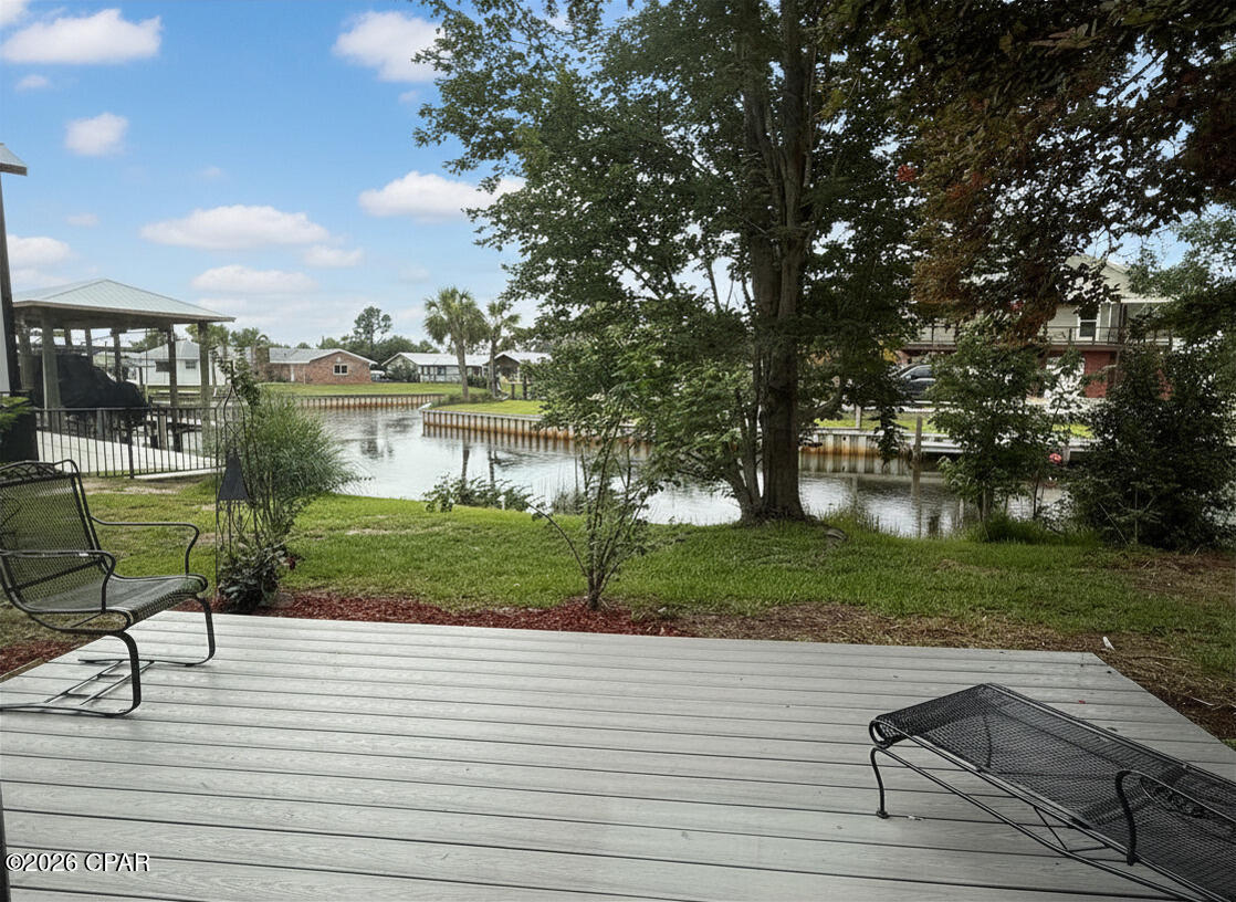 Seller is offering seller concessions for rate buy down with acceptable offer!! Welcome to waterfront living in Lynn Haven, where this beautifully remodeled 2,294 sqft all-brick home with 4 beds and 2 baths sits on an oversized double lot with approximately 150 feet of canal frontage and Gulf access. Lovingly renovated by its original owner and built to stand the test of time, this property offers the rare combination of extensive updates, incredible outdoor space, and a waterfront lifestyle that is becoming increasingly difficult to find.

Inside, the home has been thoughtfully renovated with coastal-inspired finishes throughout, sold fully furnished. The completely remodeled kitchen features custom all-plywood shaker cabinetry with soft-close doors and drawers, beautiful butcher block countertops, decorative tile backsplash, under-cabinet lighting, a wine cooler, two Lazy Susan cabinets, updated plumbing, new tile flooring, brand new appliances, and abundance of storage, including a pantry and walk in closet beneath the stairs. An oversized breakfast bar overlooks the water, creating the perfect gathering space for family and guests.

The main level offers multiple living and dining spaces, including a separate dining room, eat-in kitchen, spacious living room with crown molding, shiplap ceilings, and a brick wall with wood-burning fireplace. The primary suite is conveniently located on the first floor and features dual closets and a beautifully renovated private bath with designer tile work and updated vanity. A large laundry room provides additional storage and functionality.

Upstairs, you'll find three generously sized bedrooms, including a second primary-sized bedroom with two oversized seven-foot closets. The remodeled upstairs bathroom features a bidet, new vanity, luxury vinyl plank flooring, comfort-height toilets with soft-close lids, and stylish finishes throughout. The upstairs landing showcases additional shiplap detail, while a dedicated Christmas closet with lighting, multiple storage closets, and a private flex room ideal for an office, hobby room, or guest space provide exceptional versatility.

Throughout the home, brand-new plantation shutters and updated ceiling fans add both style and comfort. The roof was replaced in 2024, the HVAC system is approximately four years old, the water heater is less than five years old, and the septic system has recently been pumped. The home's average electric bill is approximately $110 per month, reflecting its efficiency and careful ownership.

Step outside and enjoy the true highlight of the property. A spacious deck overlooks the canal, providing the perfect setting for morning coffee, evening sunsets, or watching boats pass by on their way to the bay and Gulf waters. The oversized double lot offers endless possibilities, with ample room for a pool, detached garage, workshop, boat storage, RV parking, guest house, or future expansion. This home is also located on a dead end road with a dog park!

The grounds are a gardener's dream, showcasing an extraordinary collection of mature landscaping and fruit-bearing trees, including chocolate mimosa, grapefruit, Meyer lemon, peach, loquat, olive trees, magnolias, palm trees, crepe myrtles, Blue Moon wisteria, azaleas, Japanese camellias, rosemary, lemongrass, and rose bushes.

With Gulf access, approximately 150 feet of canal frontage, extensive renovations, and room to create your own private waterfront estate, this is a rare opportunity to own a truly special property in one of Lynn Haven's most desirable waterfront locations. Furniture is negotiable, offering the potential for a move-in-ready waterfront retreat. This home can be short term rented. 

Please note, the property appraiser site does not have the home's correct sqft or bedroom count but the info has been verified by a licensed residential appraiser and your Realtor has access to that document for review. Please verify if important.