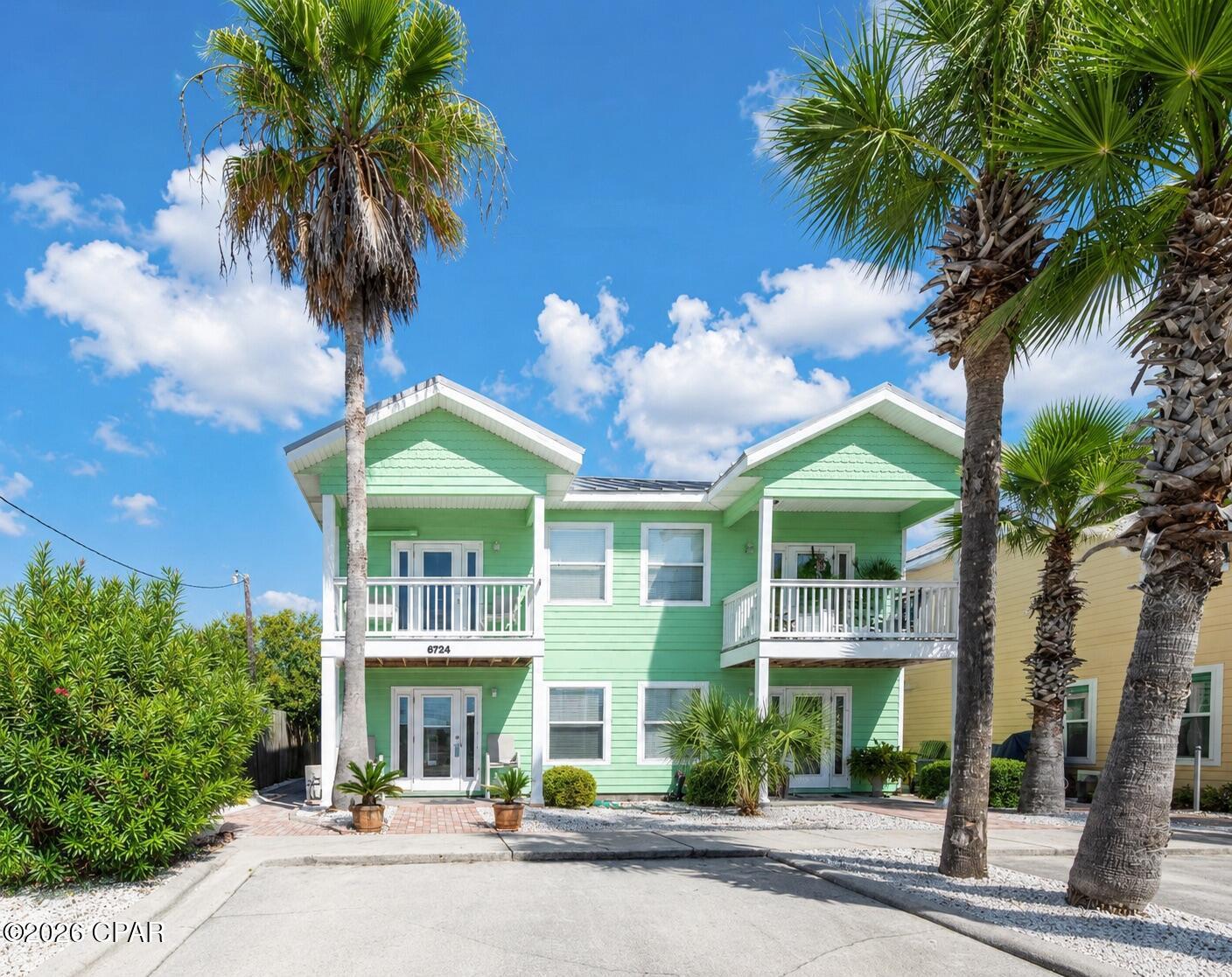 Fully Remodeled Turnkey Vacation Rental | Exceptional Investment Opportunity | Gulf Views | Proven Income Producer. Welcome to this beautifully renovated, turnkey short-term rental located in the highly sought-after Sago Park Townhomes on Thomas Drive, one of Panama City Beach's top-performing vacation rental destinations. With neighboring townhomes consistently generating over $65,000 in annual rental income, this meticulously updated property is perfectly positioned to continue delivering outstanding returns for its next owner. No expense has been spared in transforming this home into a premium vacation rental. The property underwent a comprehensive renovation, taken down to the wall studs and completely rebuilt with quality craftsmanship and modern coastal finishes throughout. Virtually everything was replaced, including: • Luxury Vinyl Plank (LVP) flooring throughout • Custom cabinetry in the kitchen and bathrooms • Elegant quartz countertops • New plumbing and lighting fixtures • Complete bathroom renovations with custom tile work • New LG kitchen appliances • Stylish, high-quality furnishings throughout The current owner has continued investing in the property to ensure it remains in top condition, including: • New HVAC evaporator coil (September 2025) • New upstairs mini-split system (August 2025) a $9,000 upgrade, professionally relocated from the front porch to the side of the home for improved aesthetics and functionality • Updated upstairs lighting • New bathroom lighting, fixtures, and cabinet hardware • New ceiling fan in the primary suite • Expanded driveway with approximately $5,000 in improvements • Hard-wired smoke detector system, fully compliant and ready for continued short-term rental operation.  As a desirable end-unit townhome, this residence offers added privacy, extra natural light, and even a glimpse of the Gulf. Located just one block from dedicated beach access, you'll enjoy the perfect combination of peaceful surroundings and unbeatable convenience. The thoughtfully designed floor plan features the main living area upstairs, where soaring ceilings and abundant natural light create an inviting space for entertaining. Guests will appreciate the convenient upstairs half bath, while downstairs you'll find two spacious primary suites, each with beautifully renovated private bathrooms featuring custom tile, modern cabinetry, updated fixtures, and designer finishes. The laundry area, complete with washer and dryer, is conveniently located on the lower level. Step outside the rear door of the second primary suite and you'll find the community pool just steps away, making this an ideal retreat for owners and vacation guests alike. Whether you're searching for a high-performing investment property, a second home, or the perfect beach getaway, this exceptional Sago Park townhome offers proven rental income, premium renovations, Gulf views, and an unbeatable Thomas Drive location just moments from the sugar-white sands of Panama City Beach. This is the turnkey investment opportunity you've been waiting for!