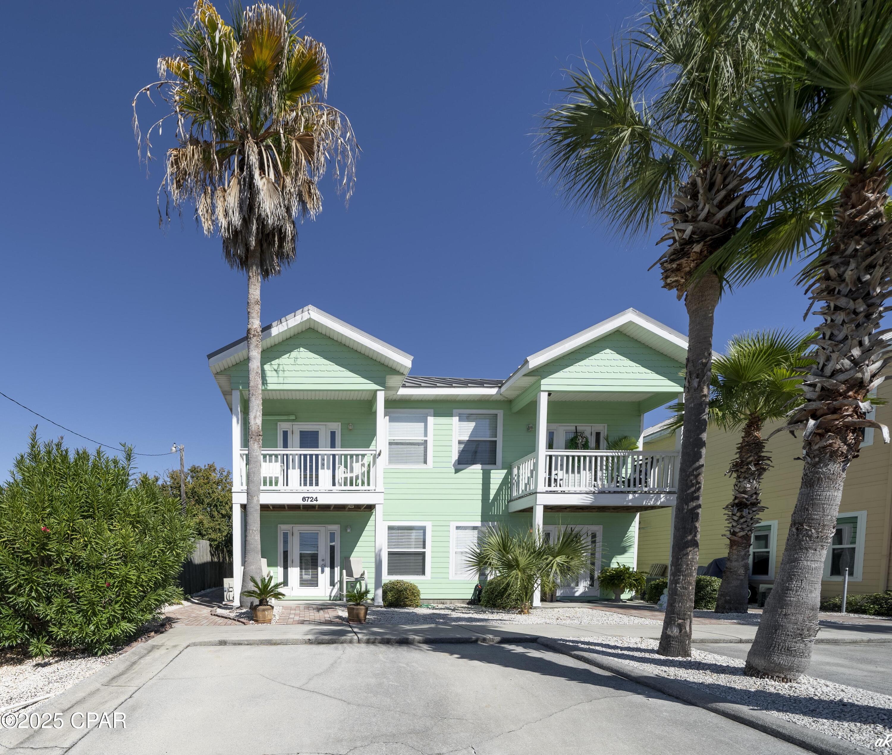 Fully Remodeled Turnkey Vacation Rental | Exceptional Investment Opportunity | Gulf Views | Proven Income Producer. Welcome to this beautifully renovated, turnkey short-term rental located in the highly sought-after Sago Park Townhomes on Thomas Drive, one of Panama City Beach's top-performing vacation rental destinations. With neighboring townhomes consistently generating over $65,000 in annual rental income, this meticulously updated property is perfectly positioned to continue delivering outstanding returns for its next owner. No expense has been spared in transforming this home into a premium vacation rental. The property underwent a comprehensive renovation, taken down to the wall studs and completely rebuilt with quality craftsmanship and modern coastal finishes throughout. Virtually everything was replaced, including: • Luxury Vinyl Plank (LVP) flooring throughout • Custom cabinetry in the kitchen and bathrooms • Elegant quartz countertops • New plumbing and lighting fixtures • Complete bathroom renovations with custom tile work • New LG kitchen appliances • Stylish, high-quality furnishings throughout The current owner has continued investing in the property to ensure it remains in top condition, including: • New HVAC evaporator coil (September 2025) • New upstairs mini-split system (August 2025) a $9,000 upgrade, professionally relocated from the front porch to the side of the home for improved aesthetics and functionality • Updated upstairs lighting • New bathroom lighting, fixtures, and cabinet hardware • New ceiling fan in the primary suite • Expanded driveway with approximately $5,000 in improvements • Hard-wired smoke detector system, fully compliant and ready for continued short-term rental operation.  As a desirable end-unit townhome, this residence offers added privacy, extra natural light, and even a glimpse of the Gulf. Located just one block from dedicated beach access, you'll enjoy the perfect combination of peaceful surroundings and unbeatable convenience. The thoughtfully designed floor plan features the main living area upstairs, where soaring ceilings and abundant natural light create an inviting space for entertaining. Guests will appreciate the convenient upstairs half bath, while downstairs you'll find two spacious primary suites, each with beautifully renovated private bathrooms featuring custom tile, modern cabinetry, updated fixtures, and designer finishes. The laundry area, complete with washer and dryer, is conveniently located on the lower level. Step outside the rear door of the second primary suite and you'll find the community pool just steps away, making this an ideal retreat for owners and vacation guests alike. Whether you're searching for a high-performing investment property, a second home, or the perfect beach getaway, this exceptional Sago Park townhome offers proven rental income, premium renovations, Gulf views, and an unbeatable Thomas Drive location just moments from the sugar-white sands of Panama City Beach. This is the turnkey investment opportunity you've been waiting for!