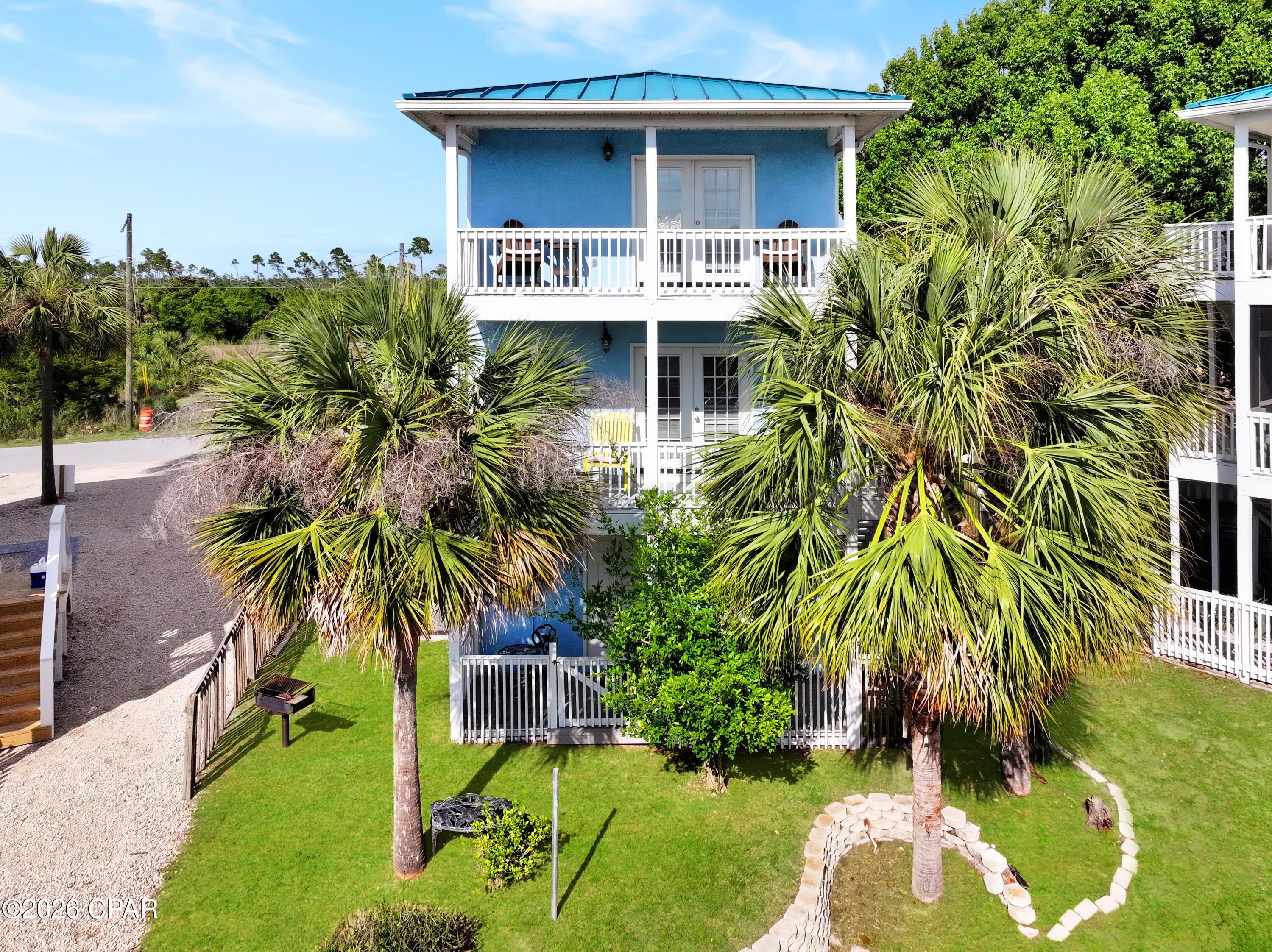 Welcome to your coastal escape in beautiful Mexico Beach! This beautifully updated 3-story home offers the perfect beach retreat with a bright, open layout designed for easy living and entertaining. Featuring 2 bedrooms, 2.5 bathrooms, this home is designed to maximize comfort while embracing coastal living. Enjoy spacious living areas, plenty of natural light, and outdoor spaces perfect for relaxing in the coastal breeze.  Situated on a canal-front lot, this property also features a seawall, adding to its appeal for those who love life near the water. Additional highlights include central HVAC, a standing seam metal roof, driveway, and fenced areas for added convenience.  Located just a short walk, golf cart ride, or bike ride to Mexico Beach's sugar-white sands, local restaurants, and shops, this property is ideal as a primary residence, vacation getaway, or investment opportunity. Experience the laid-back lifestyle Mexico Beach is known for in this move-in-ready coastal home.